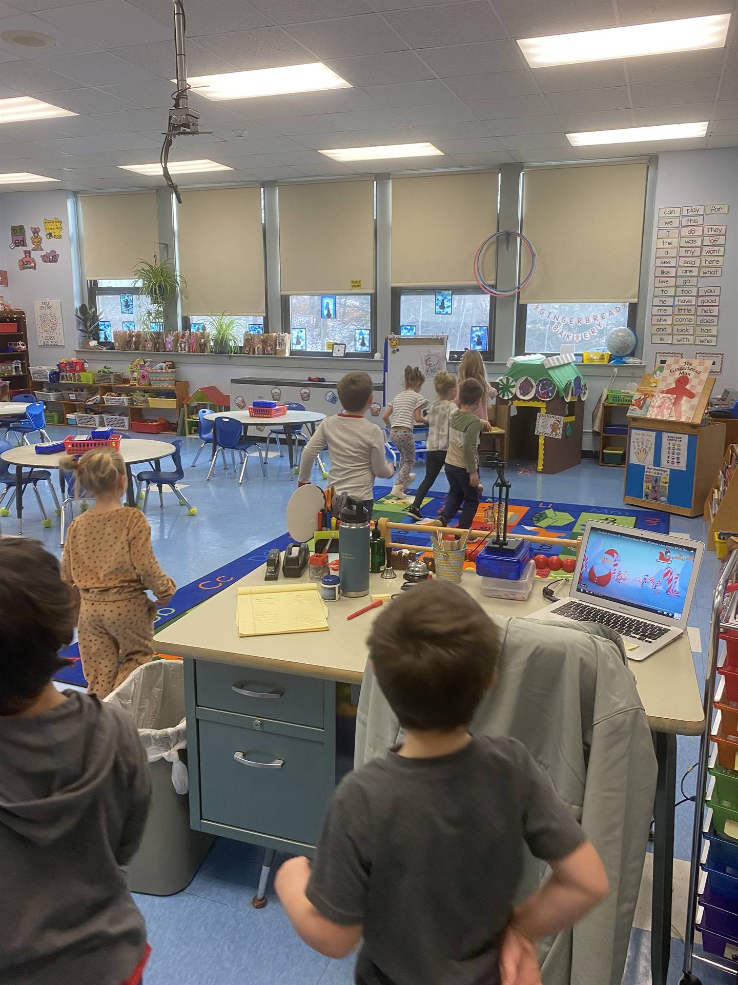 students walk toward the giant gingerbread house