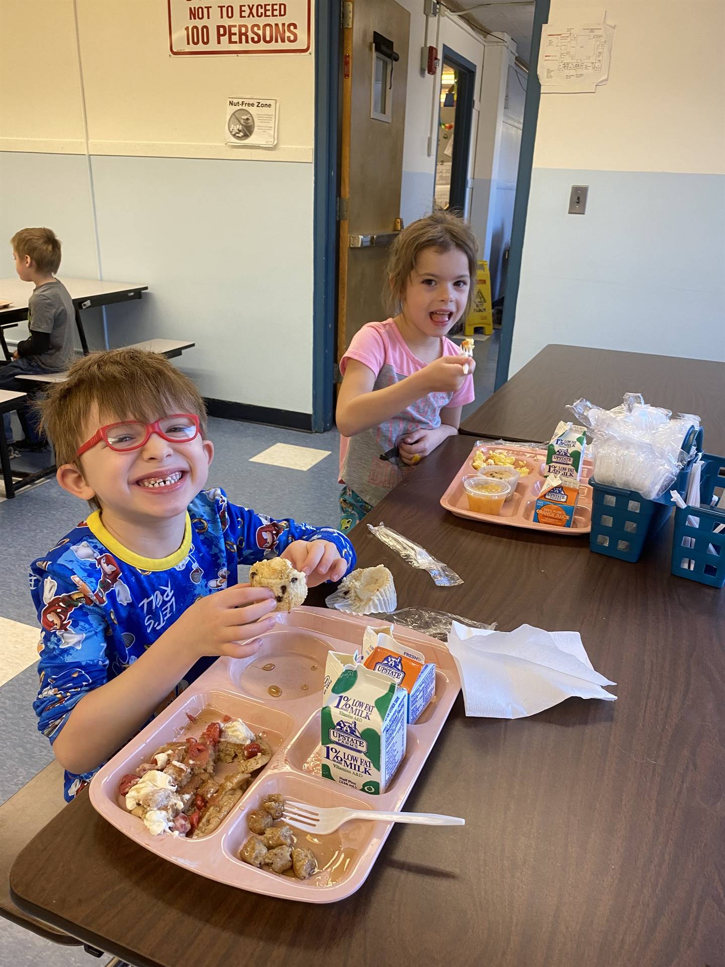 students decorating gingerbread houses. 