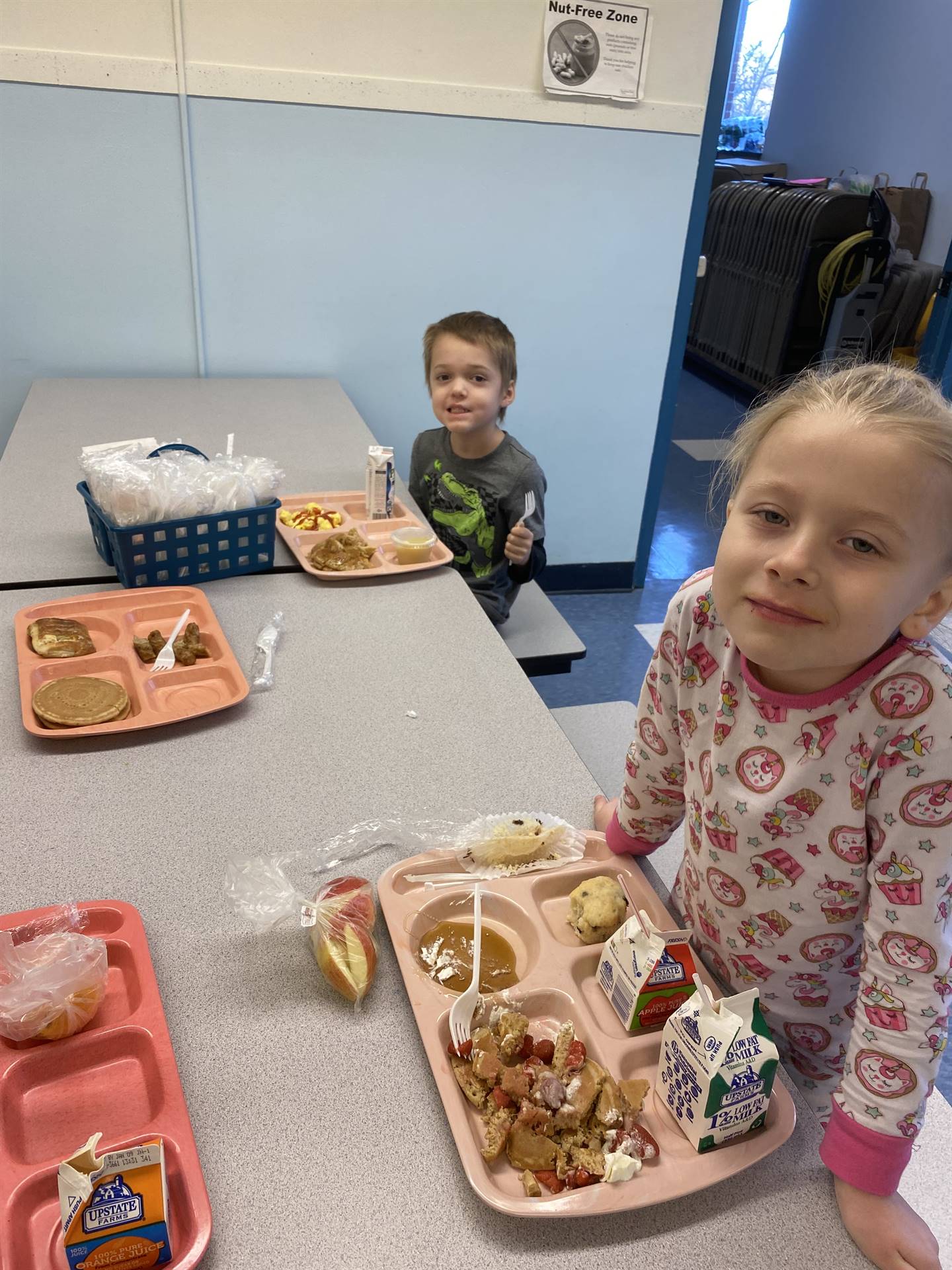 students decorating gingerbread houses. 