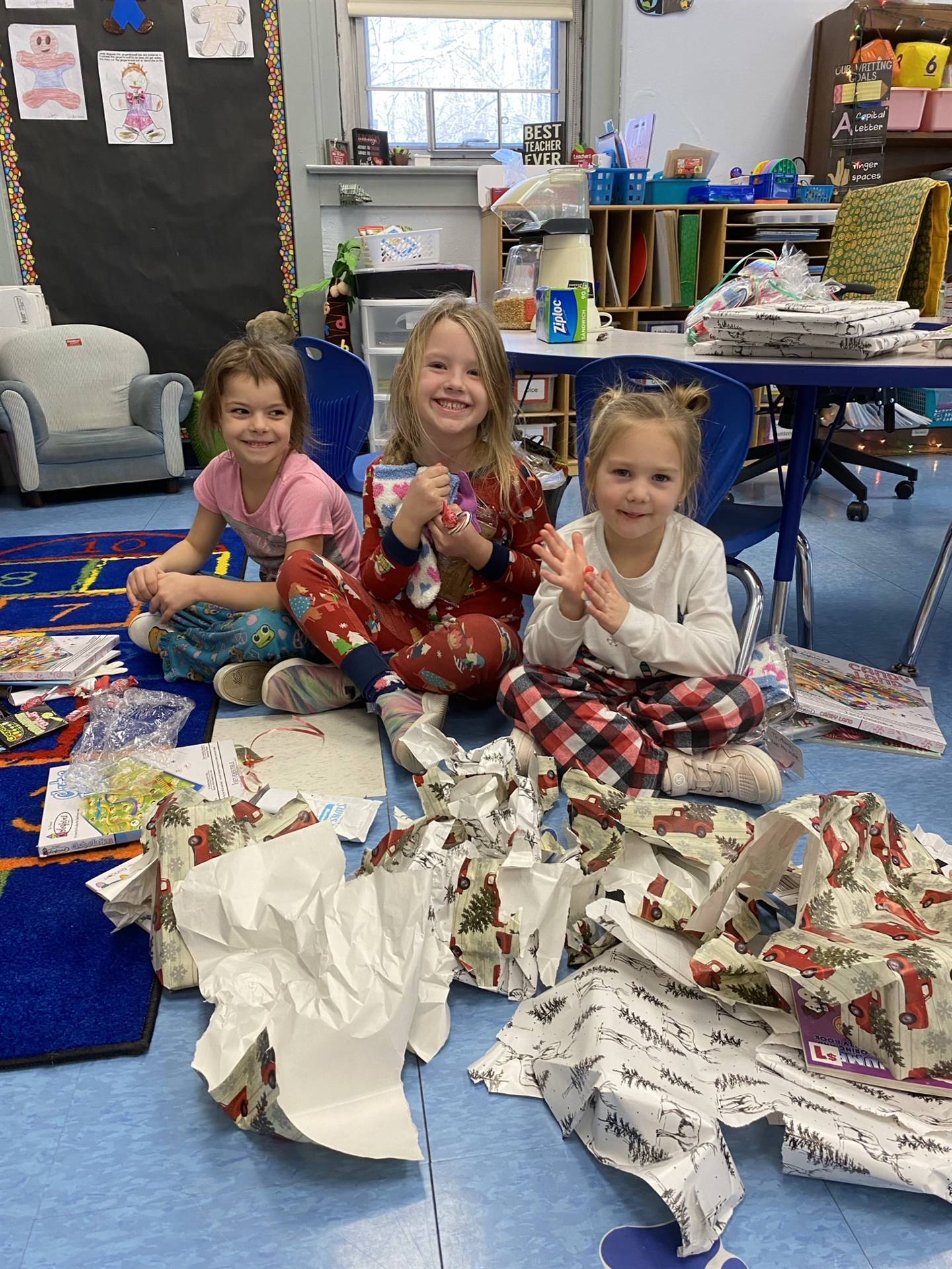 students decorating gingerbread houses. 