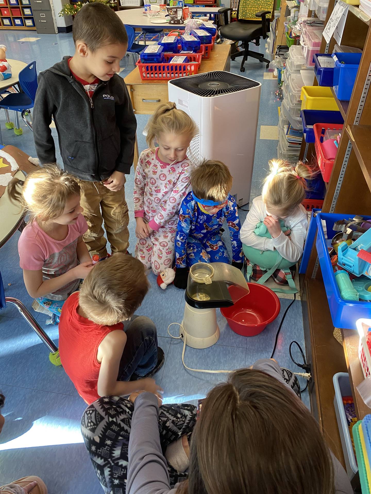 students and teacher making popcorn