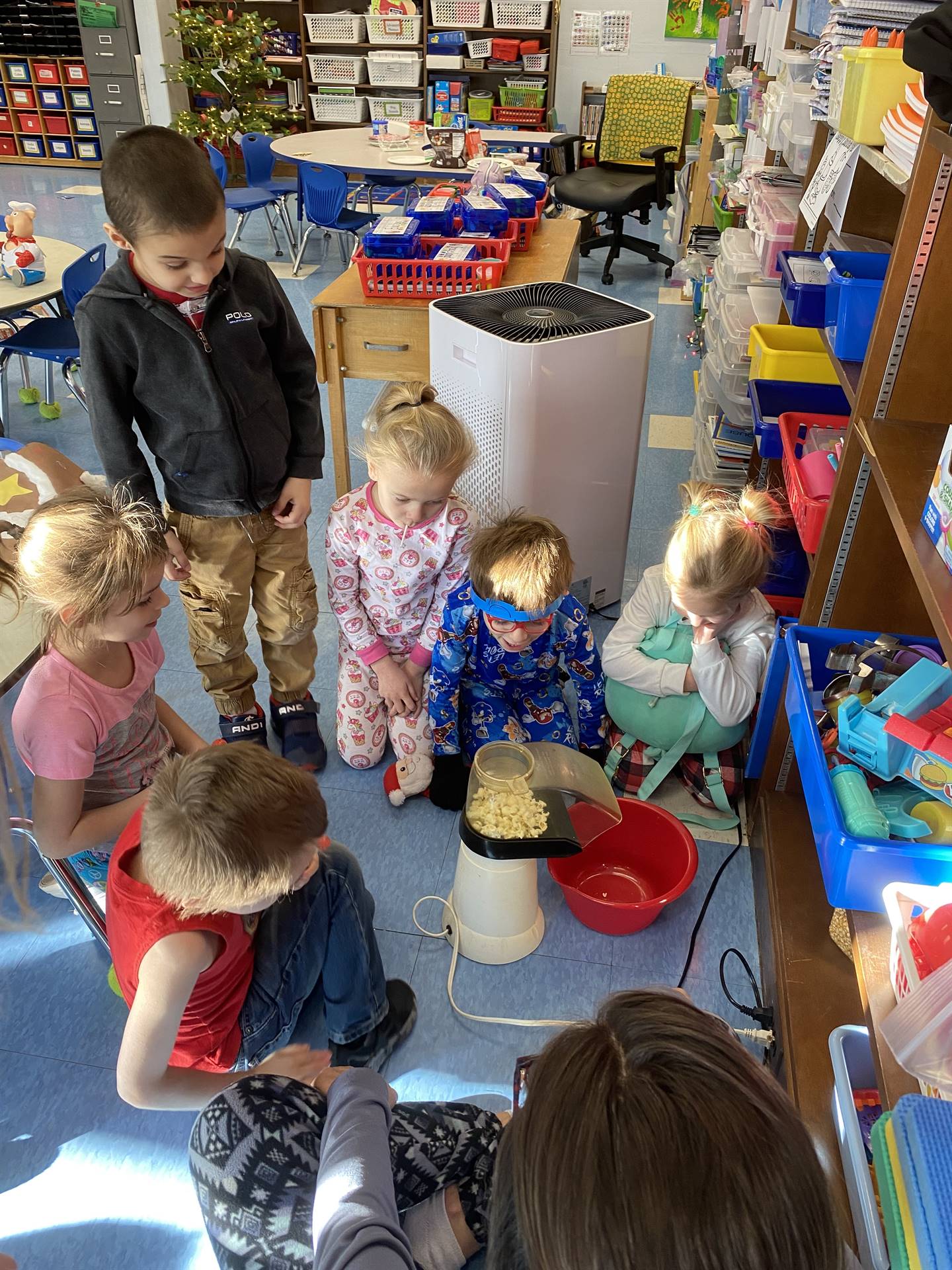students and teacher making popcorn
