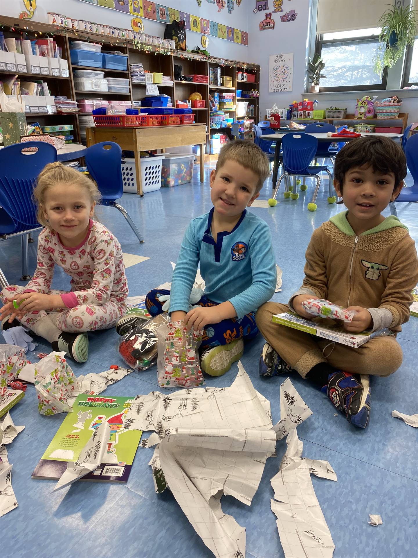 students decorating gingerbread houses. 