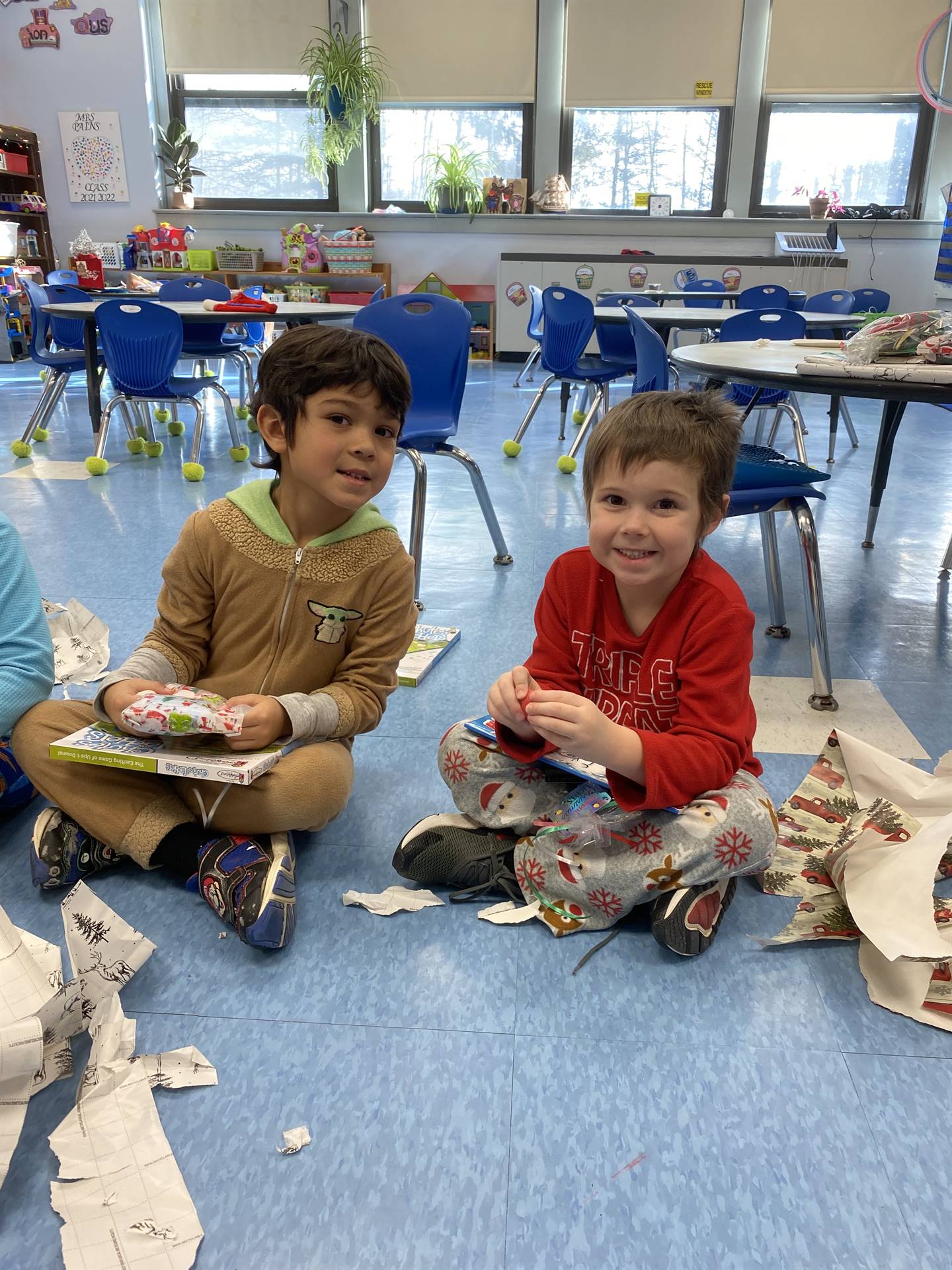 students decorating gingerbread houses. 