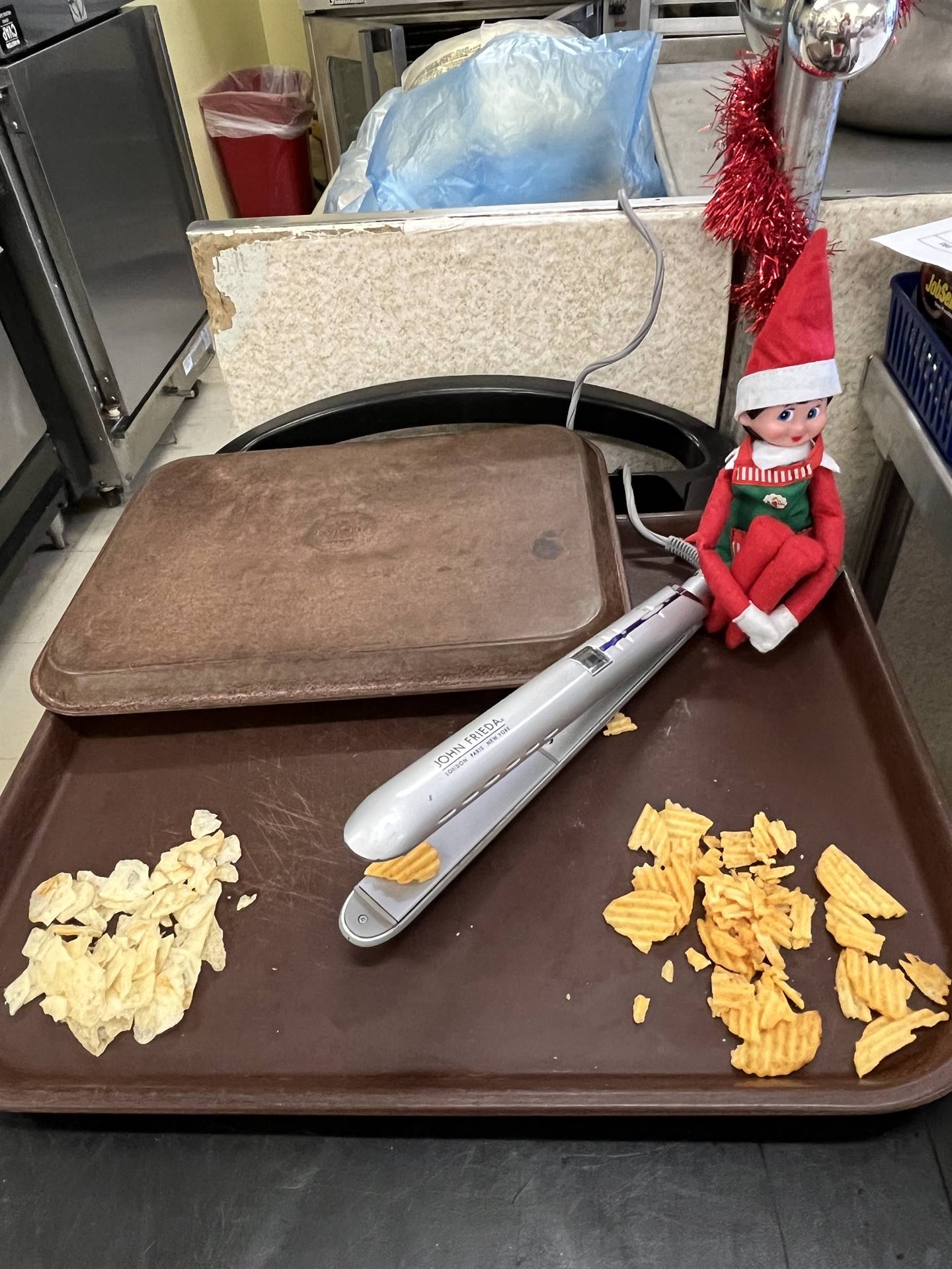 Elf using curling iron to straighten out ridge potato chips