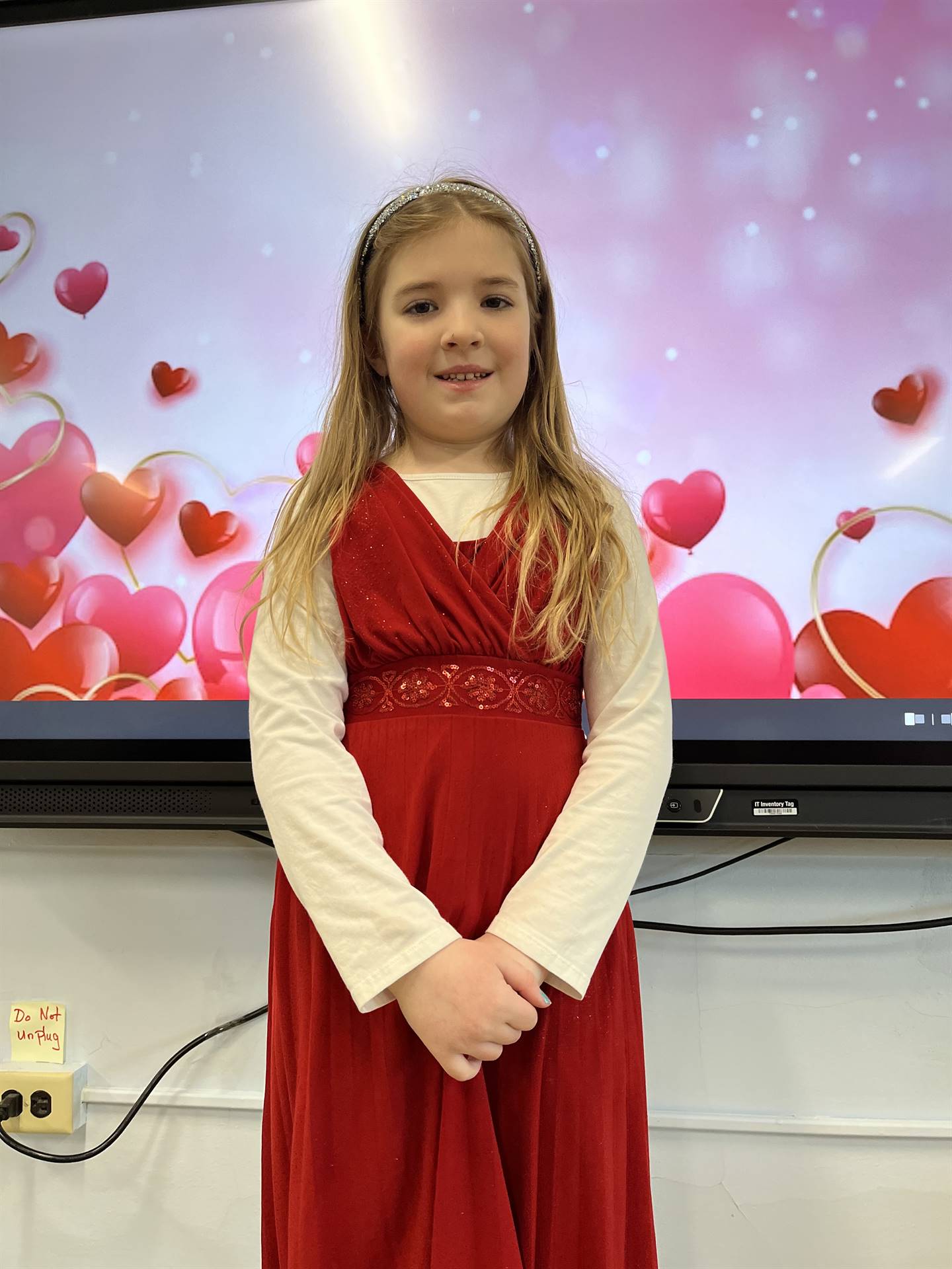 1 student in red dress with heart background