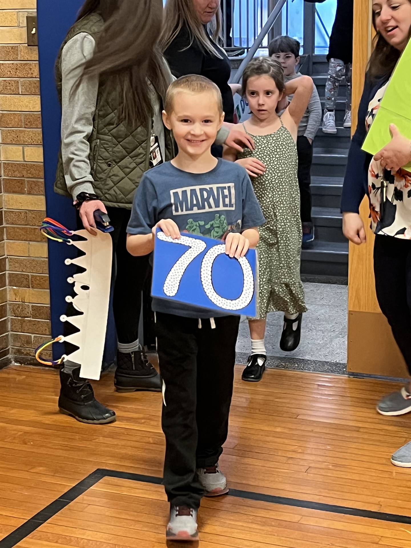 a student holding 70 sign