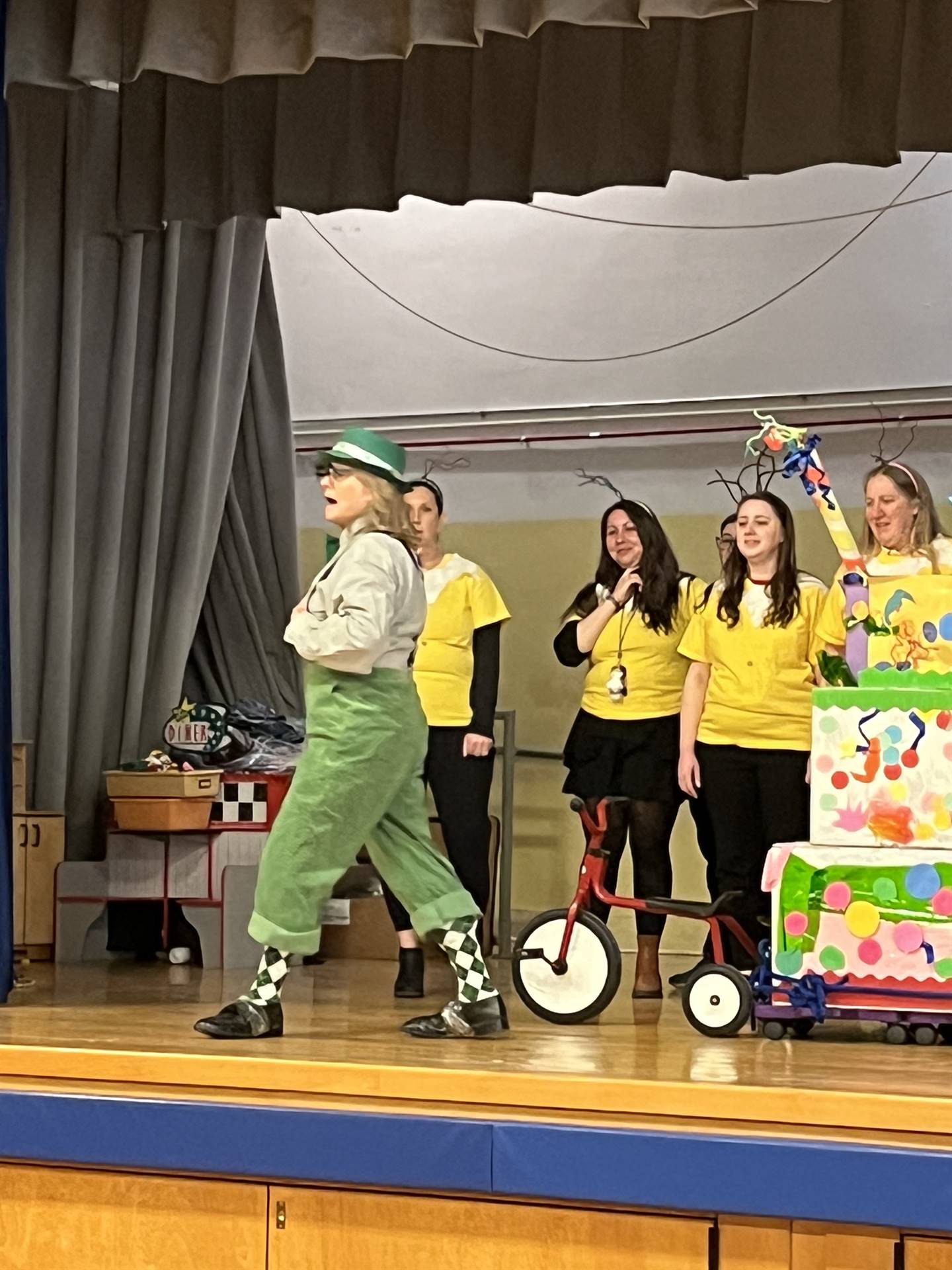 Sylvester McBean pulling his machine while teachers dressed as sneetches watch.