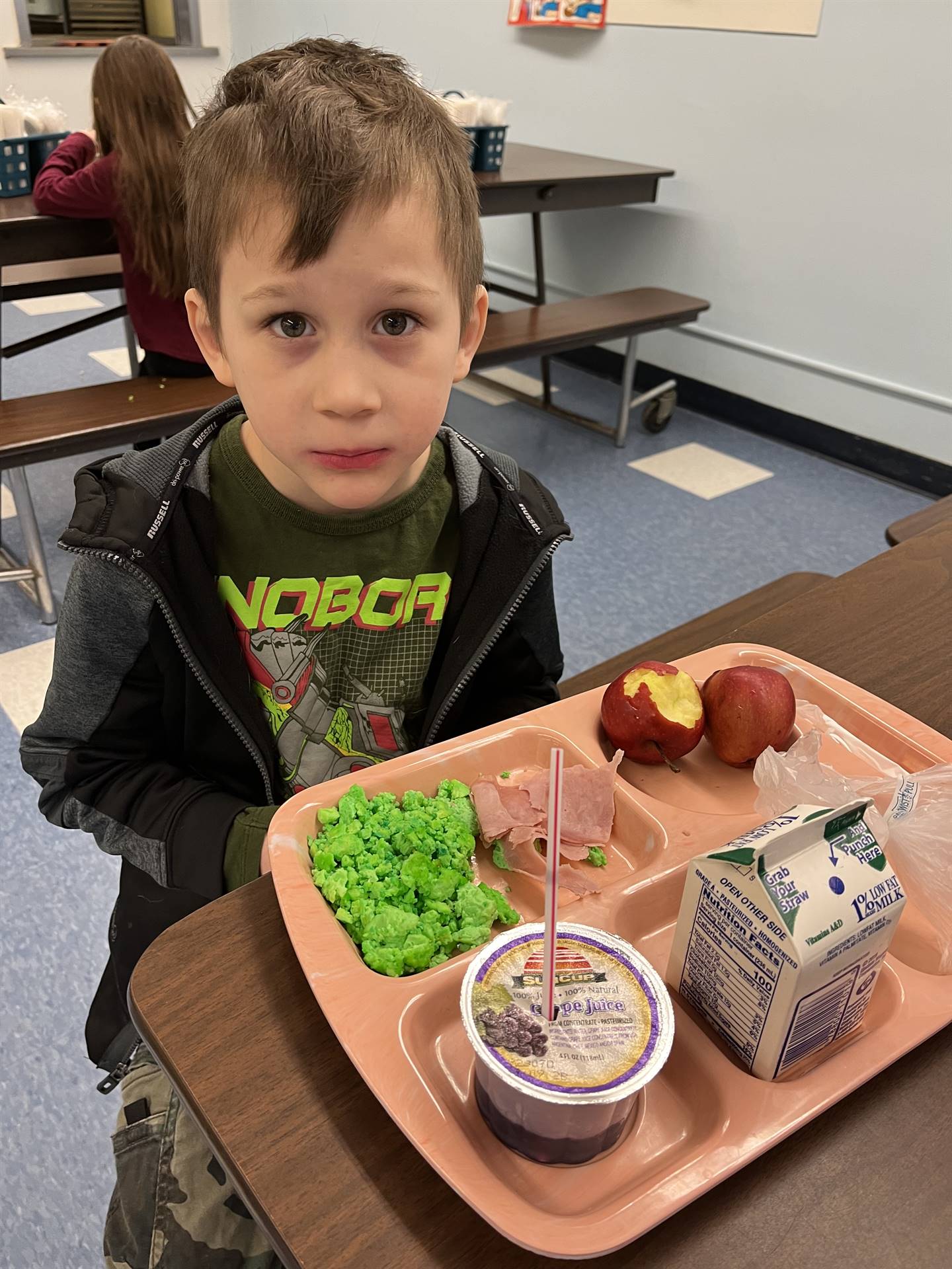 a student looks worried about trying green eggs for breakfast!
