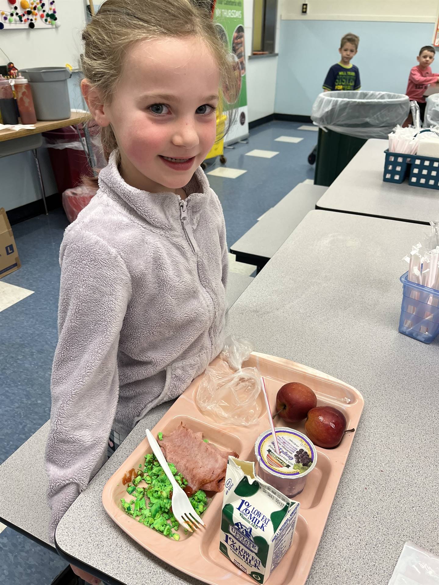 a student smiling for green eggs and ham for breakfast!