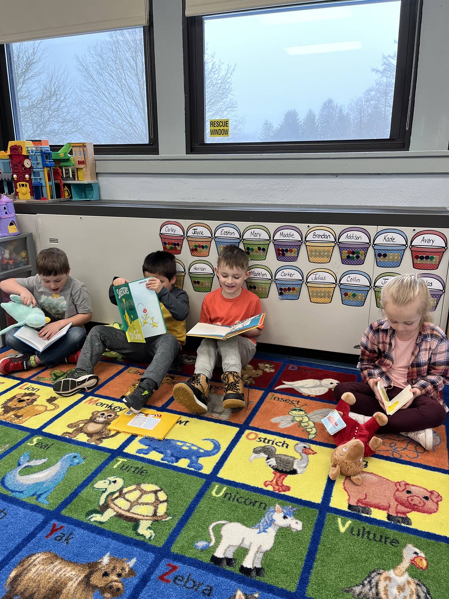 students reading books to their stuffed animals.