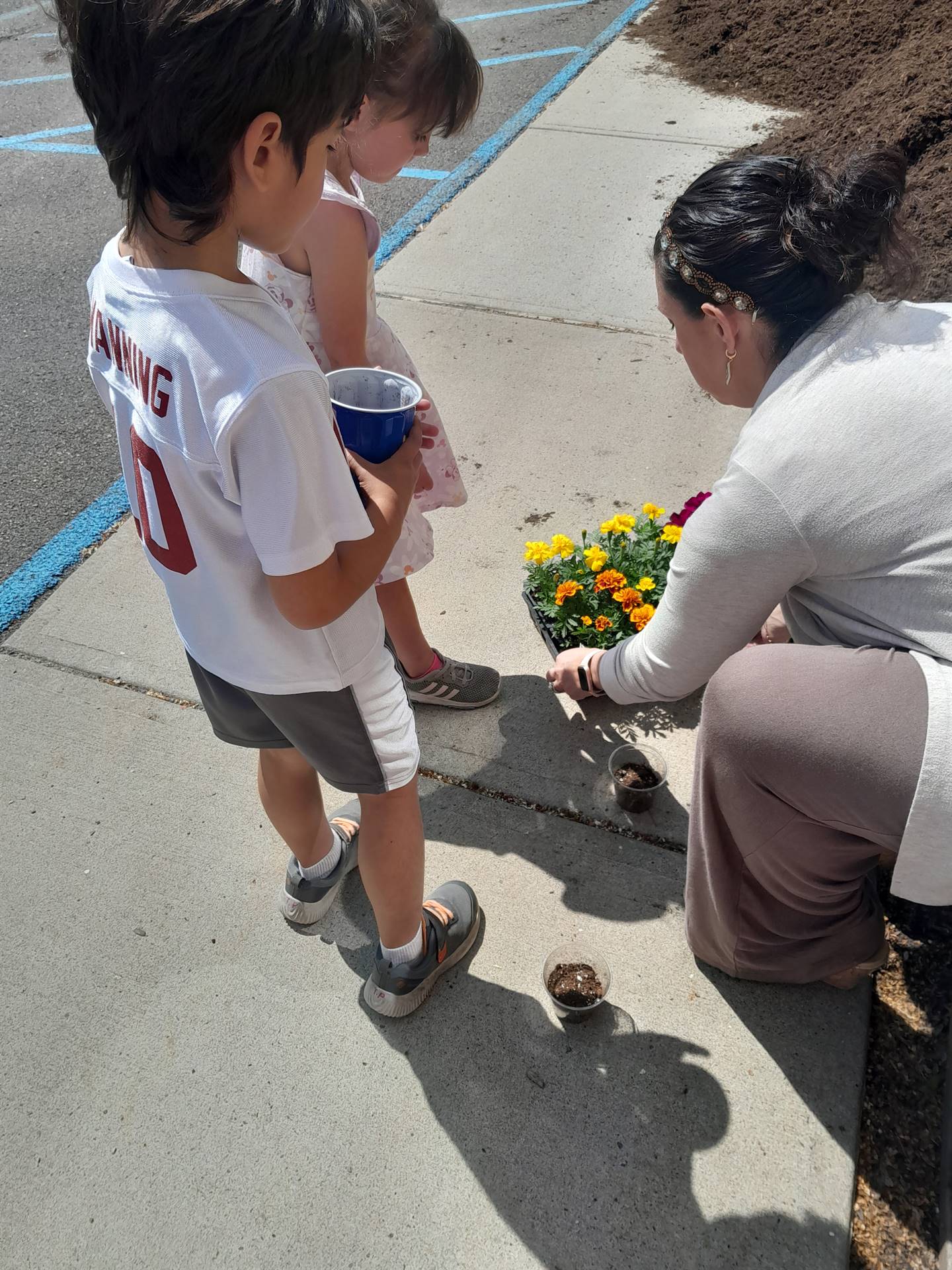 a student and teacher are planting 