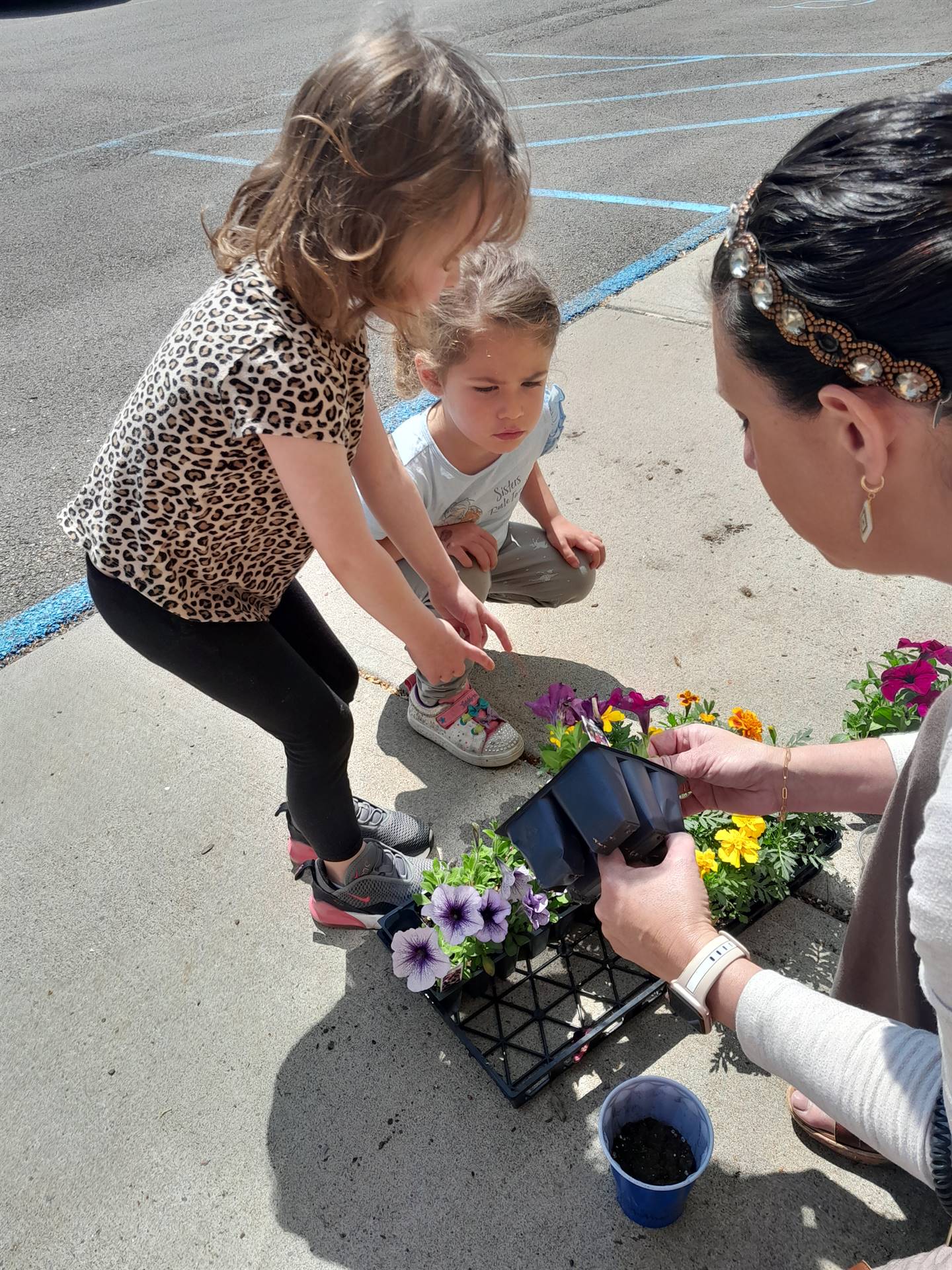 2 students are digging soil from a bucket