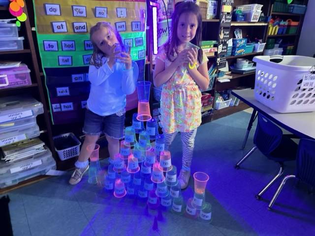 2 students stacking cups.