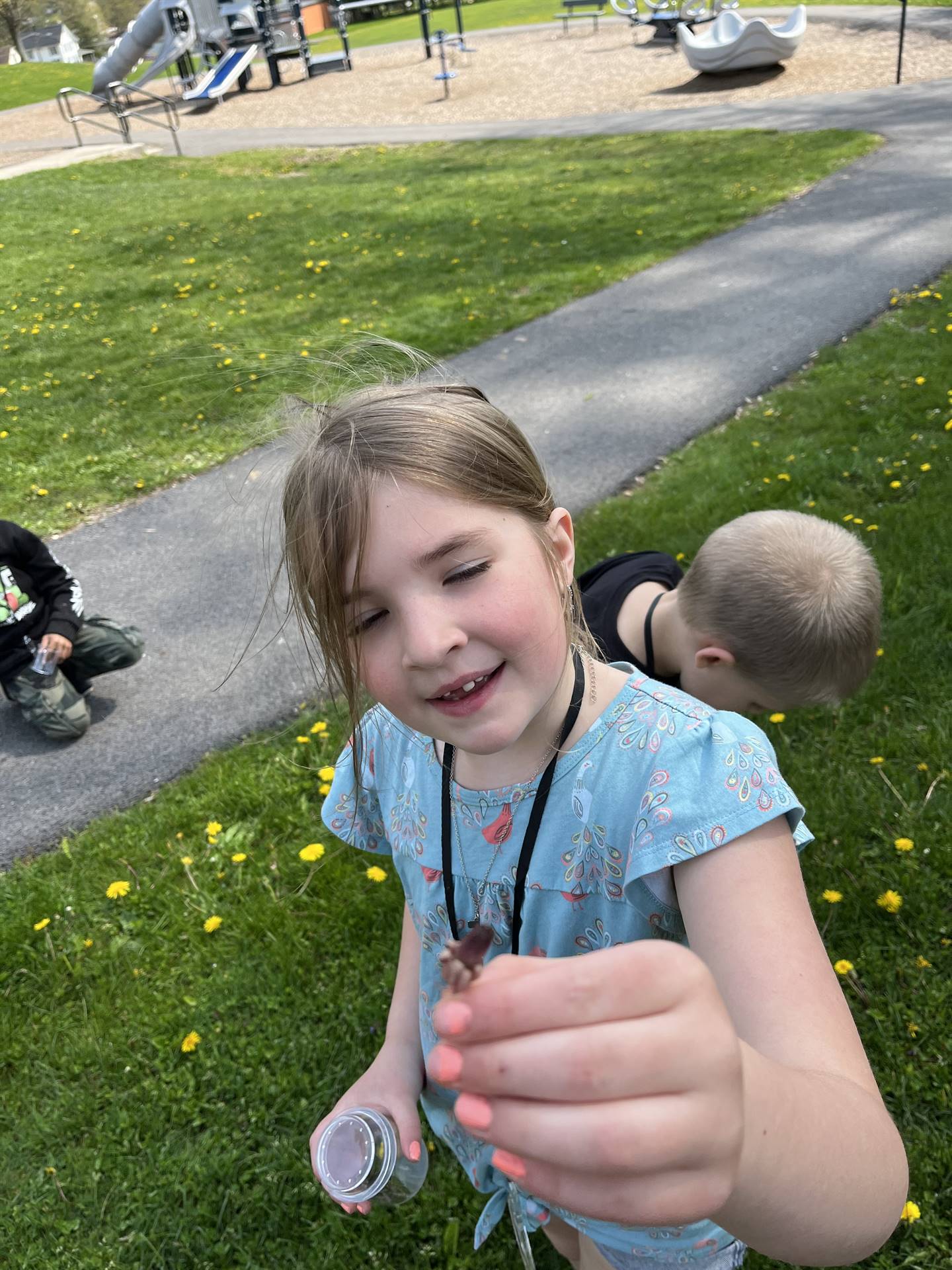 a student holds up a tiny seed bud