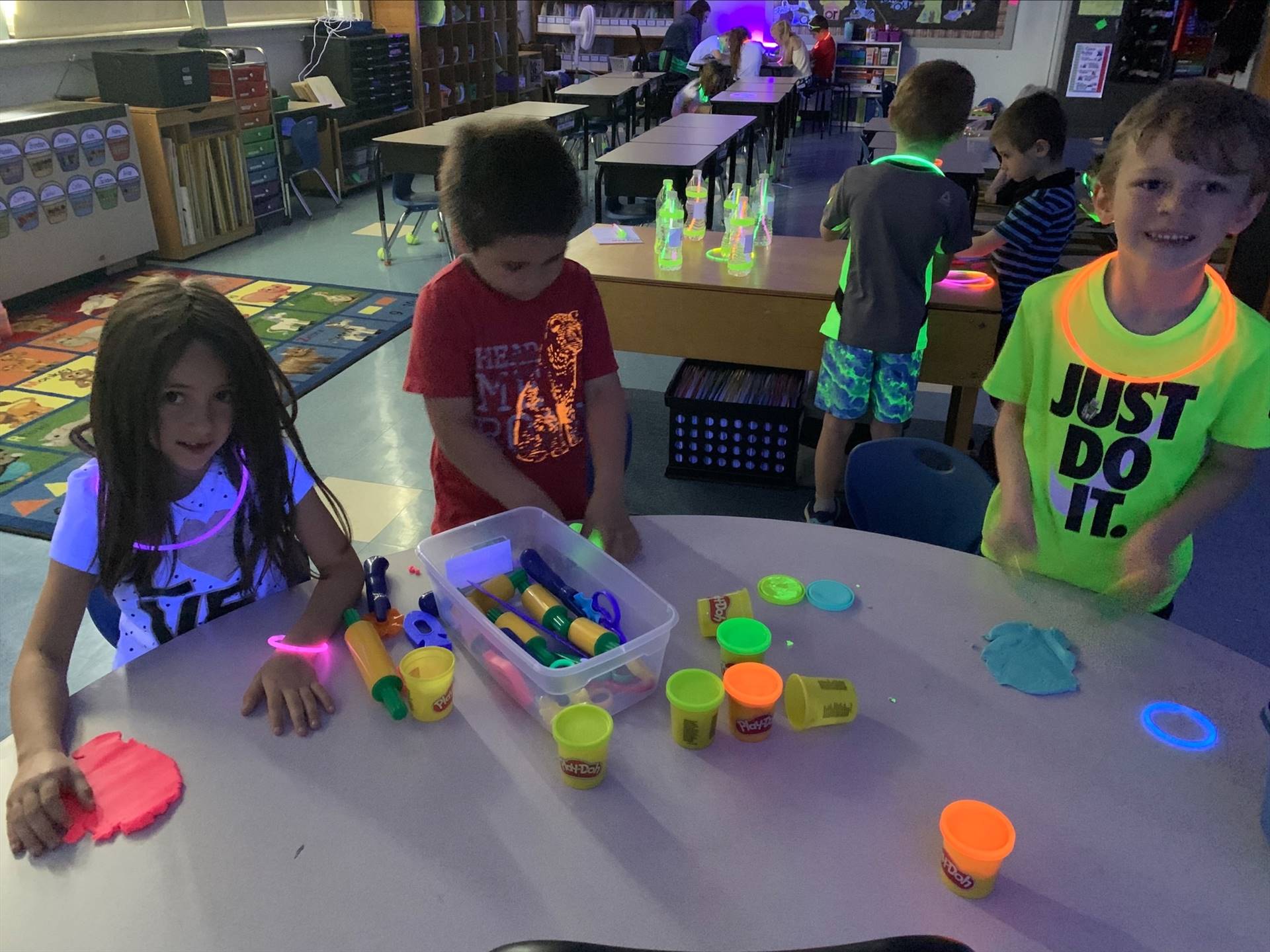 3 students playing with glowing play do