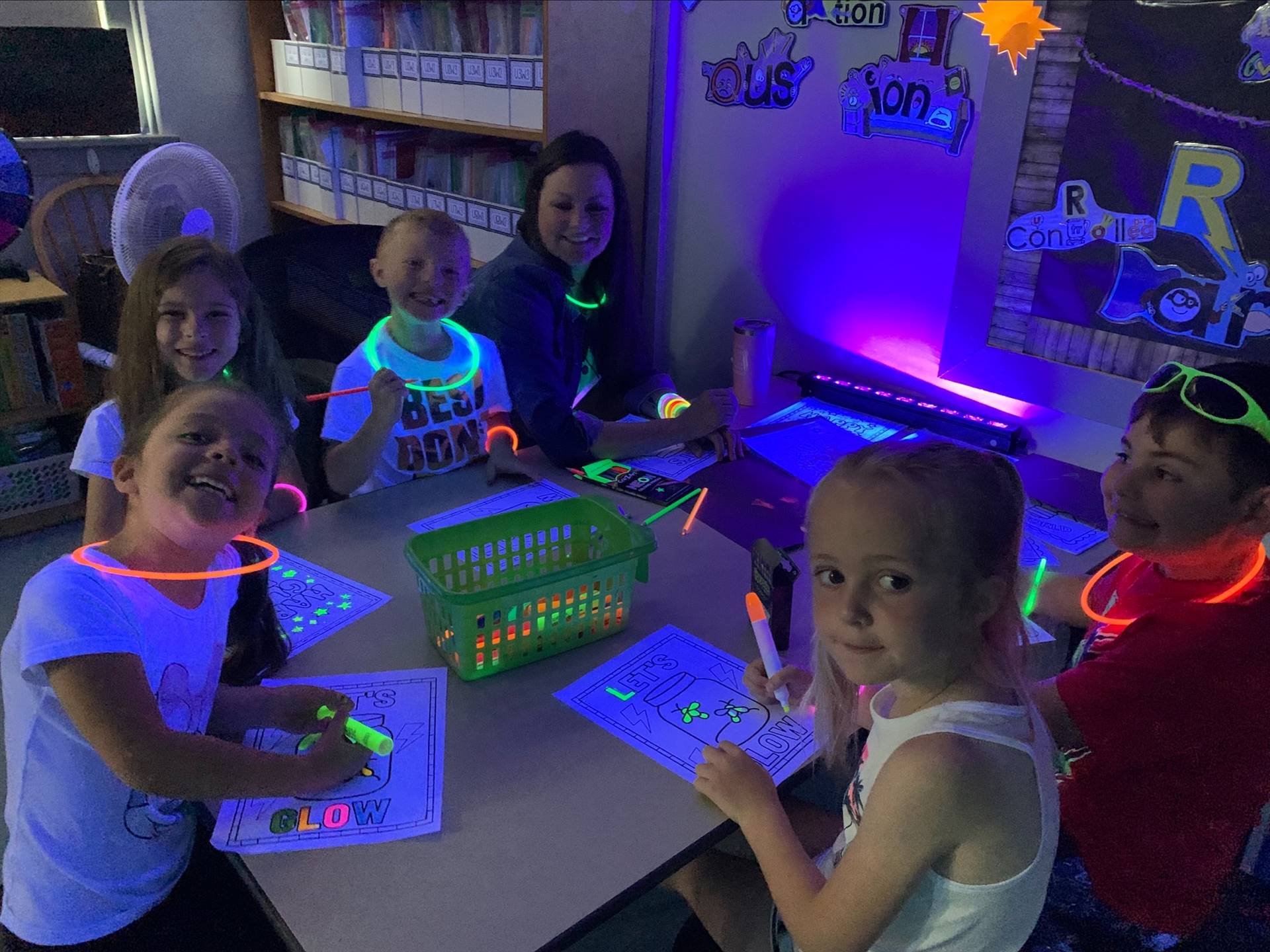 students drawing with neon glow pens.
