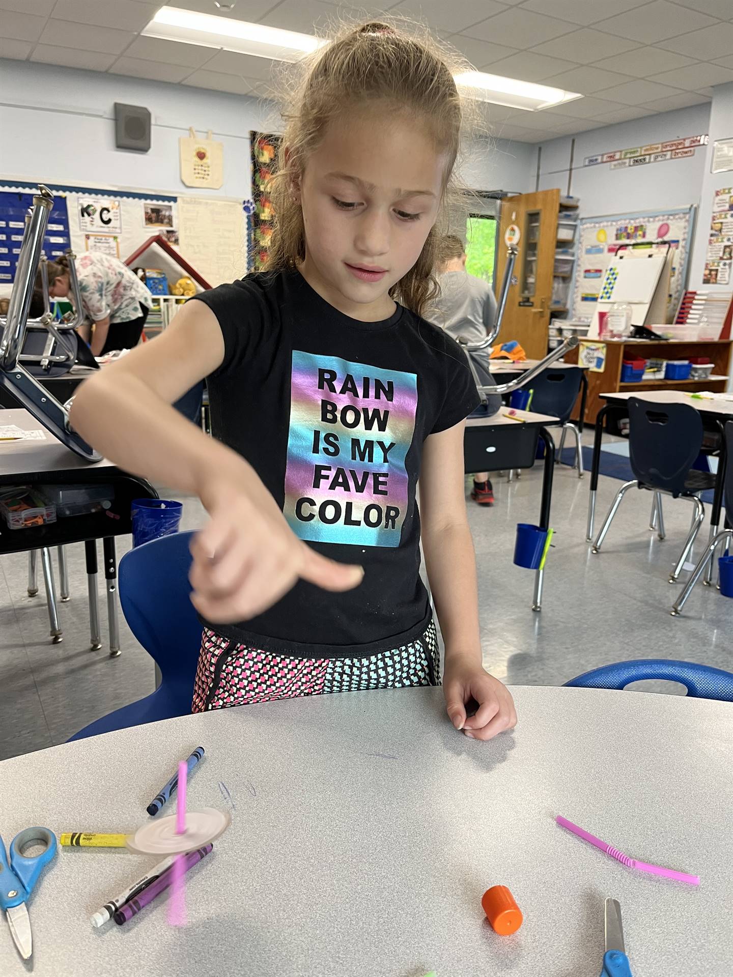 students trying out their homemade spinning tops