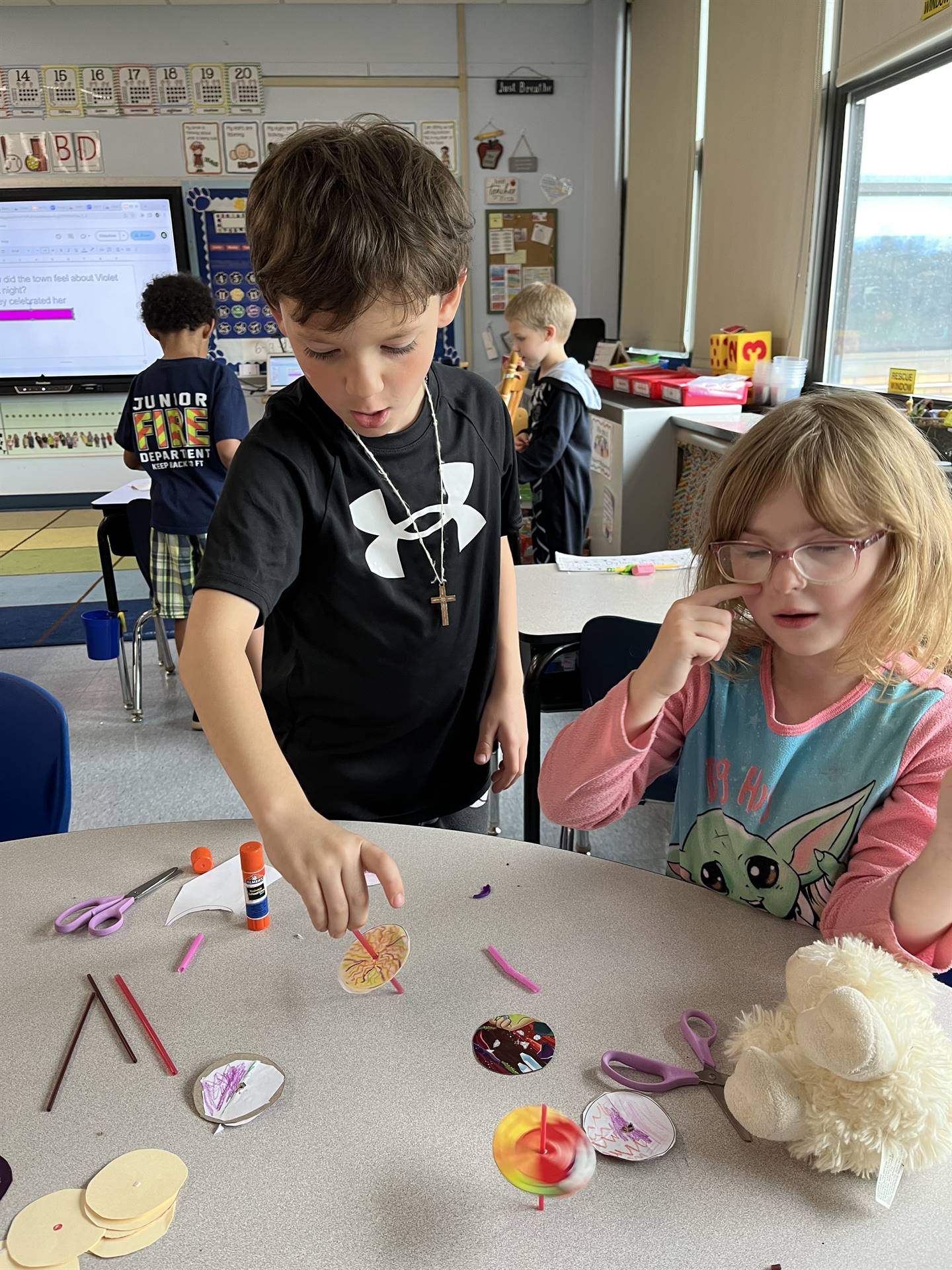 students trying out their homemade spinning tops