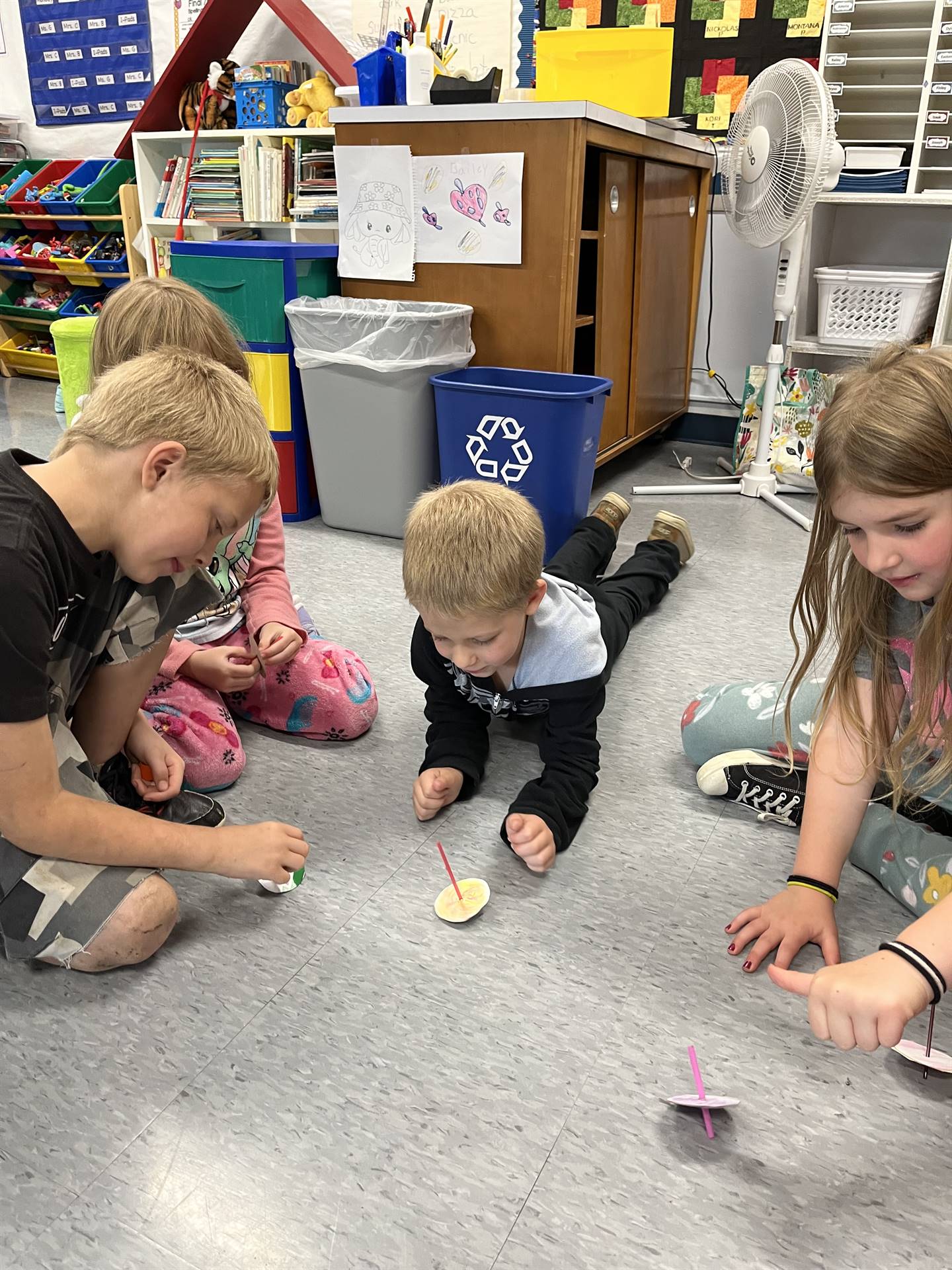 students trying out their homemade spinning tops