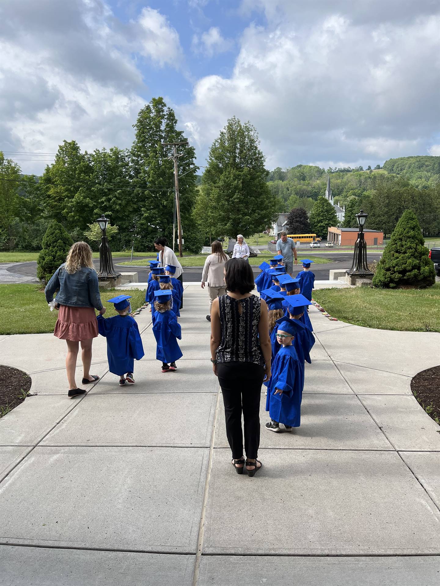 Pre K students walking out to meet a bus