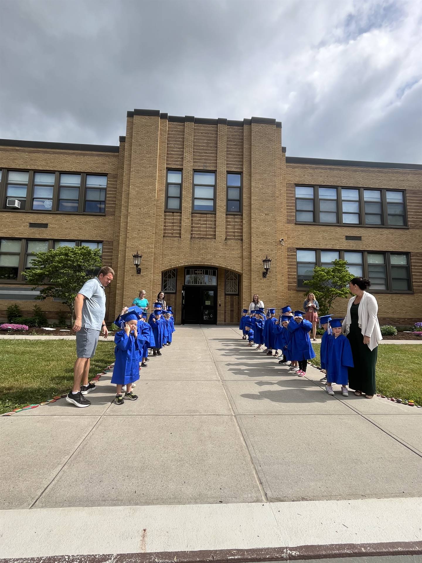 Pre K student graduates lined up to meet Seniors