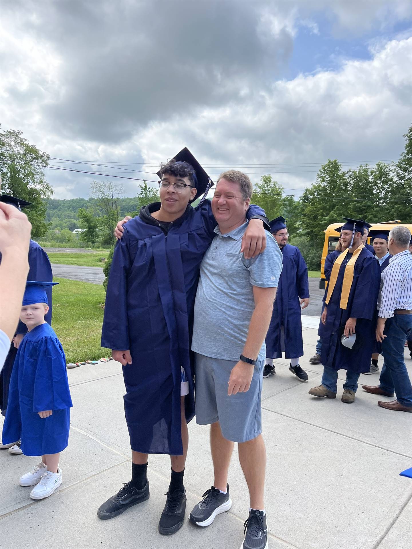 a senior graduate with his K teacher