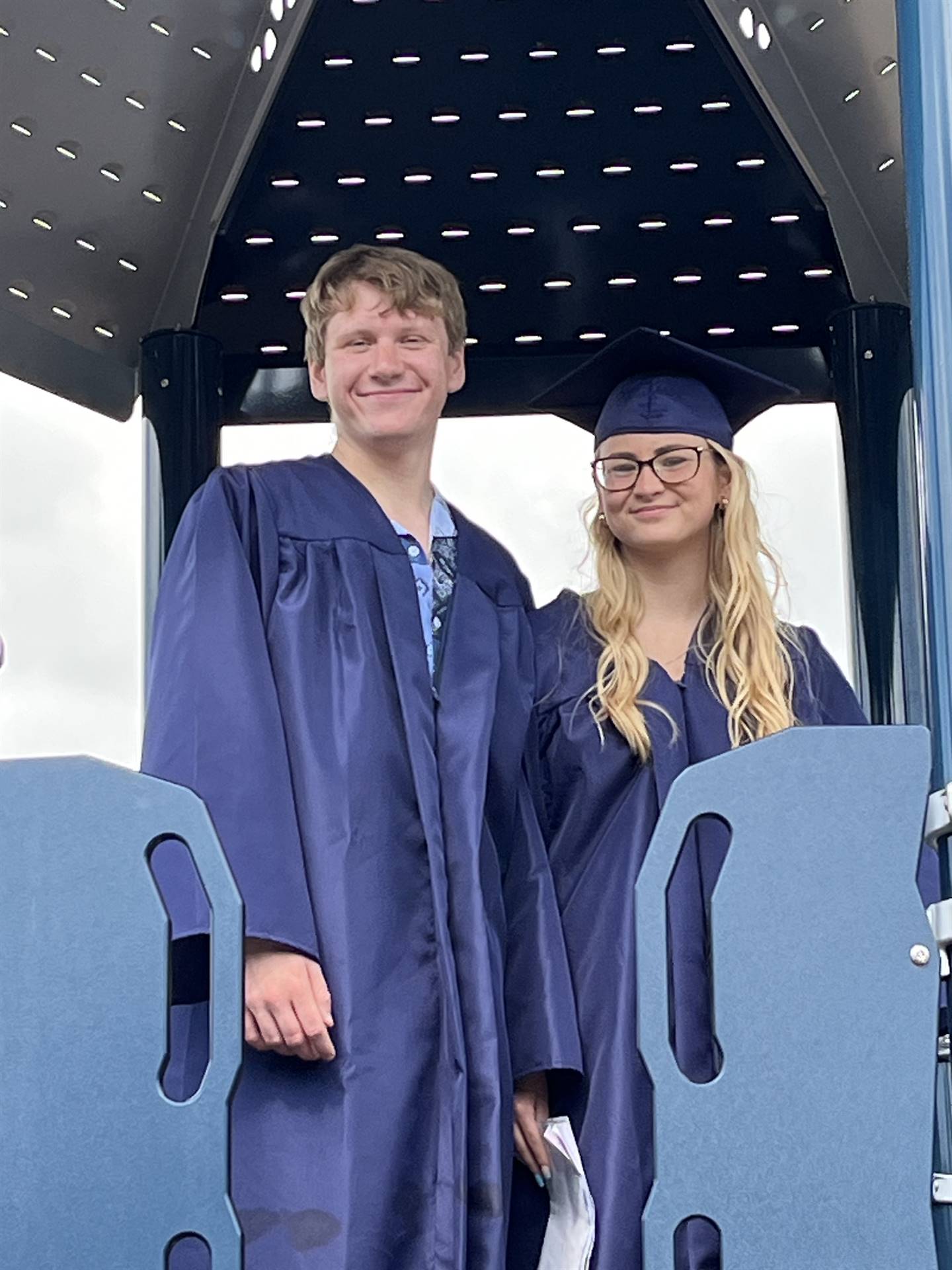 2 senior graduates on playground