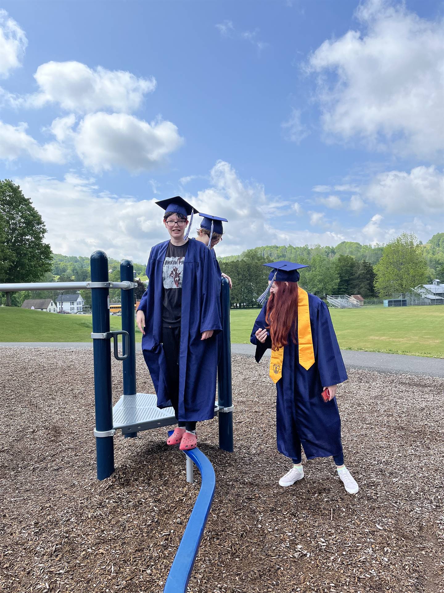 2 senior graduates on playground