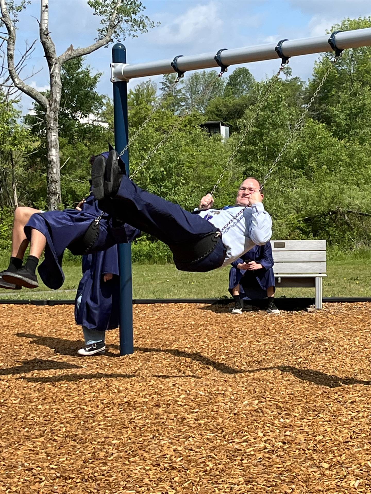 High School principal on playground swing