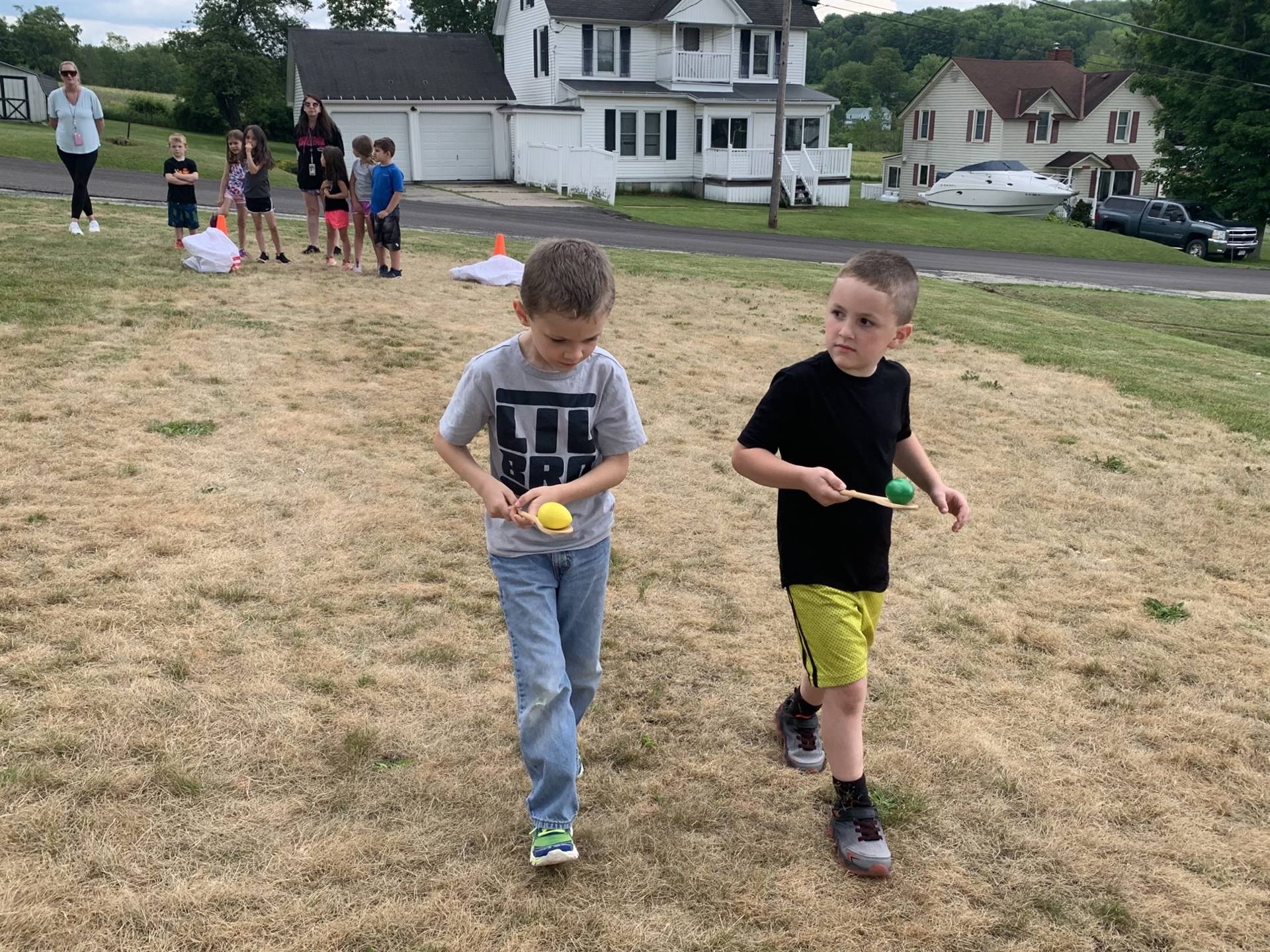 children balancing eggs on a spoon