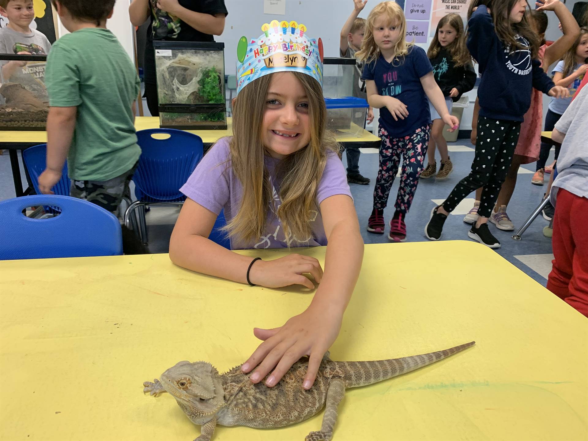 a student pets a lizard