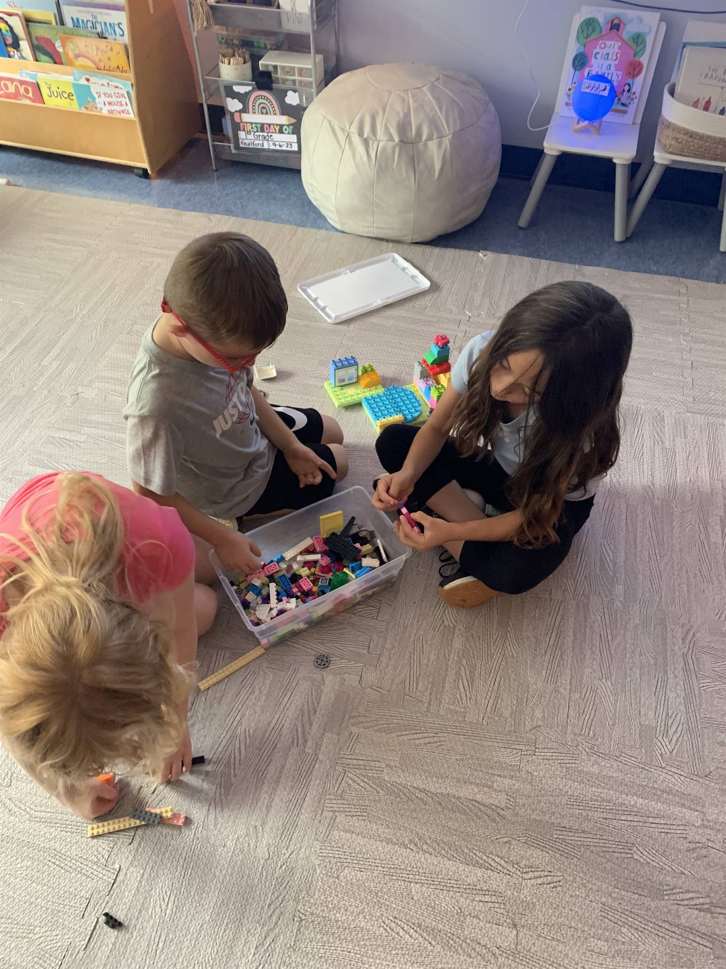 3 students playing with toys