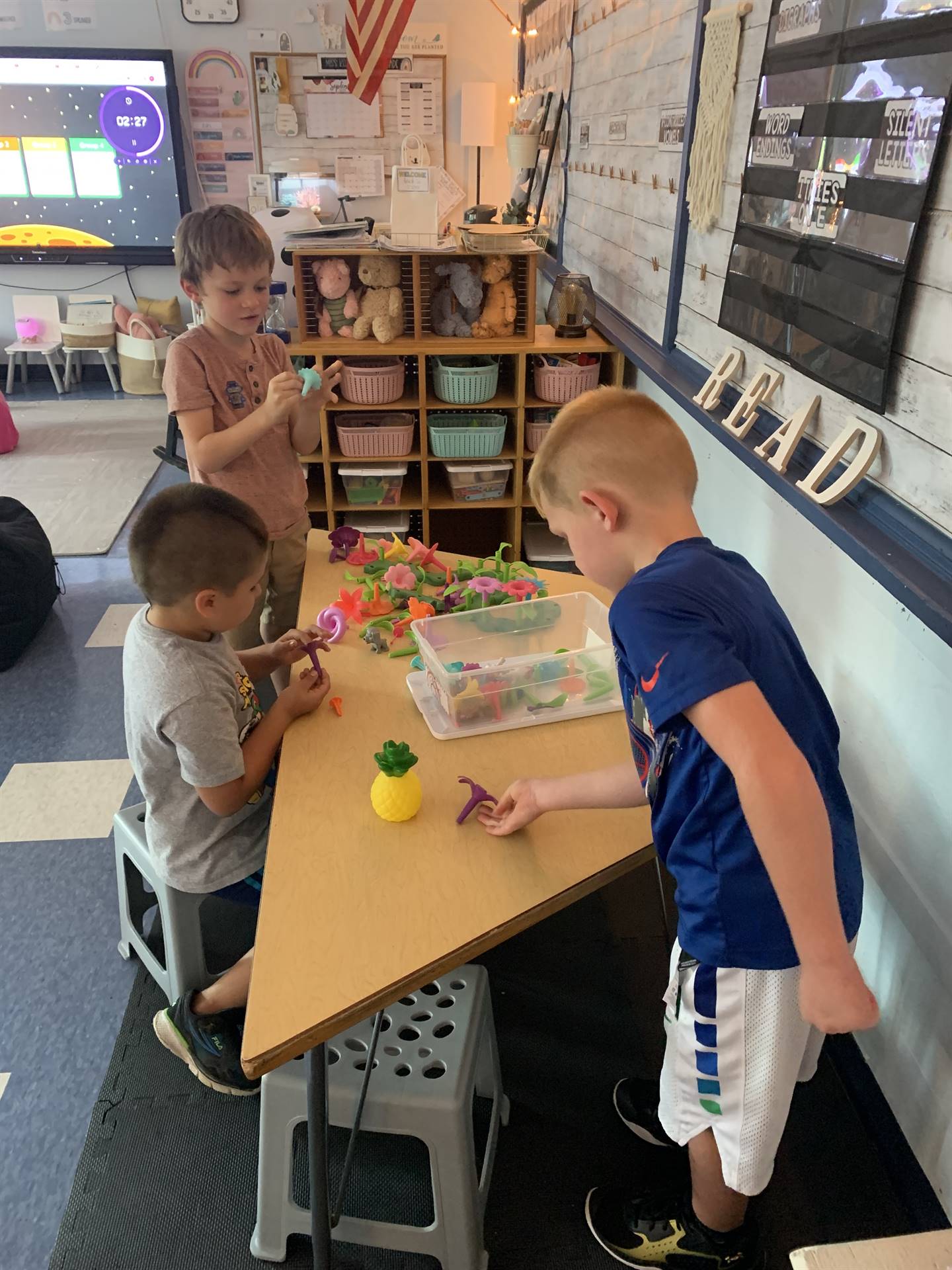 3 students playing with toys