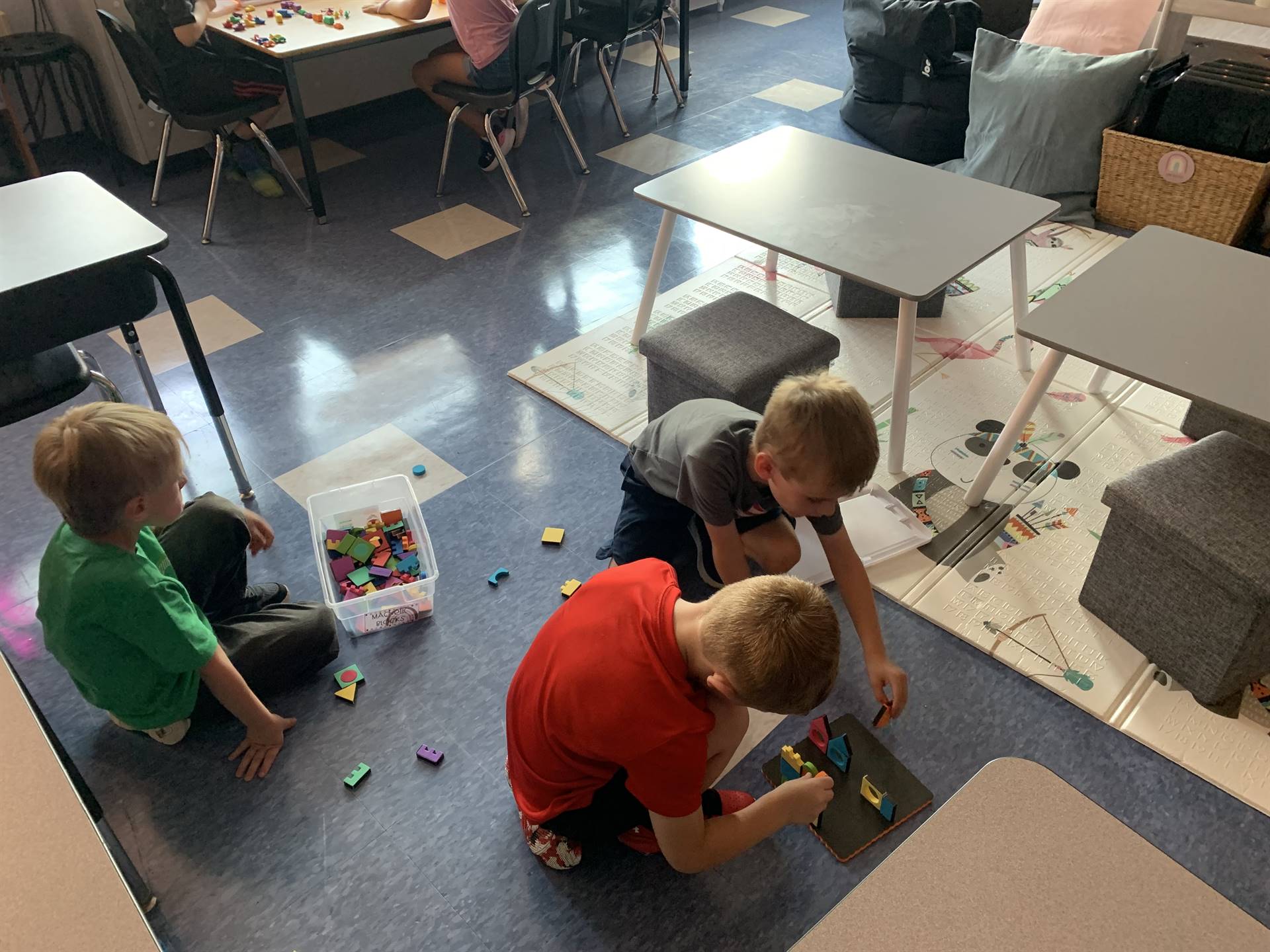 3 students playing with toys