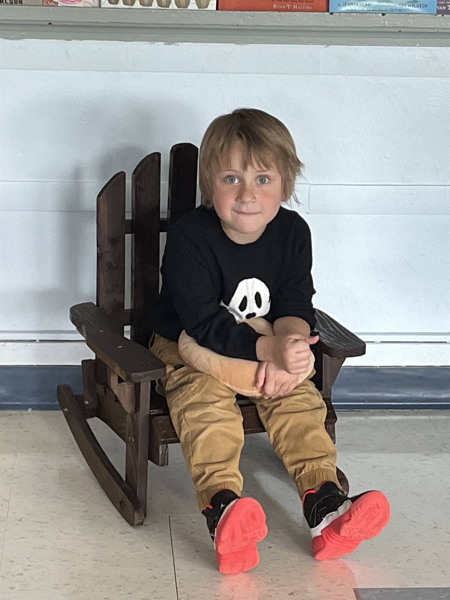 A student takes a break to clear his mind in a rocking chair.