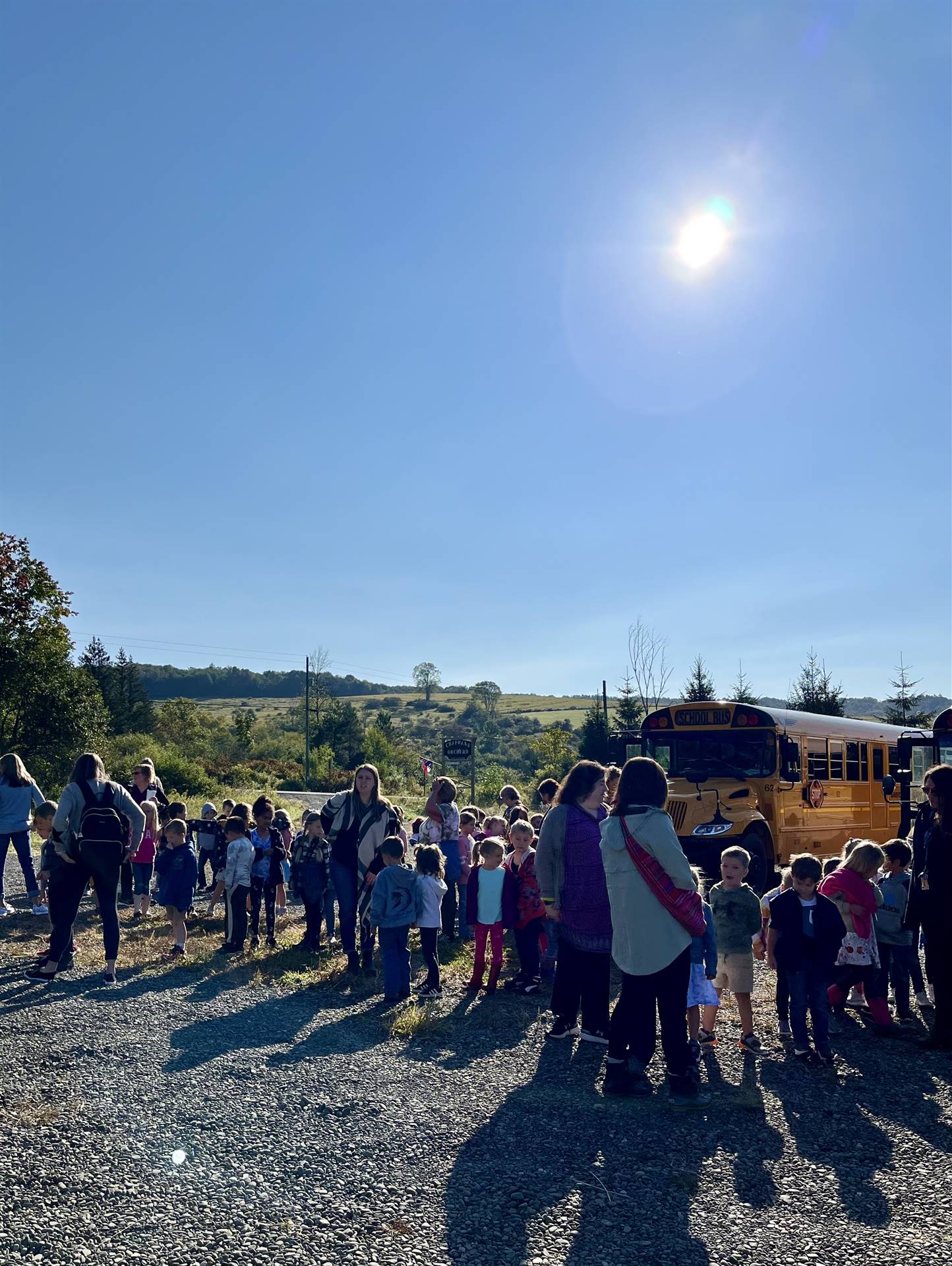 students outside waiting to visit an apple orchard.