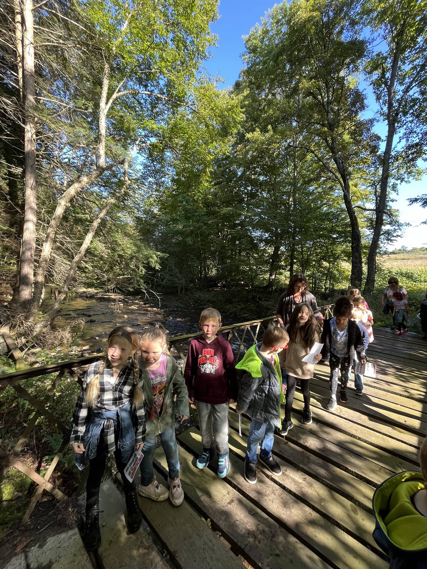 a group of students walking across a bridge