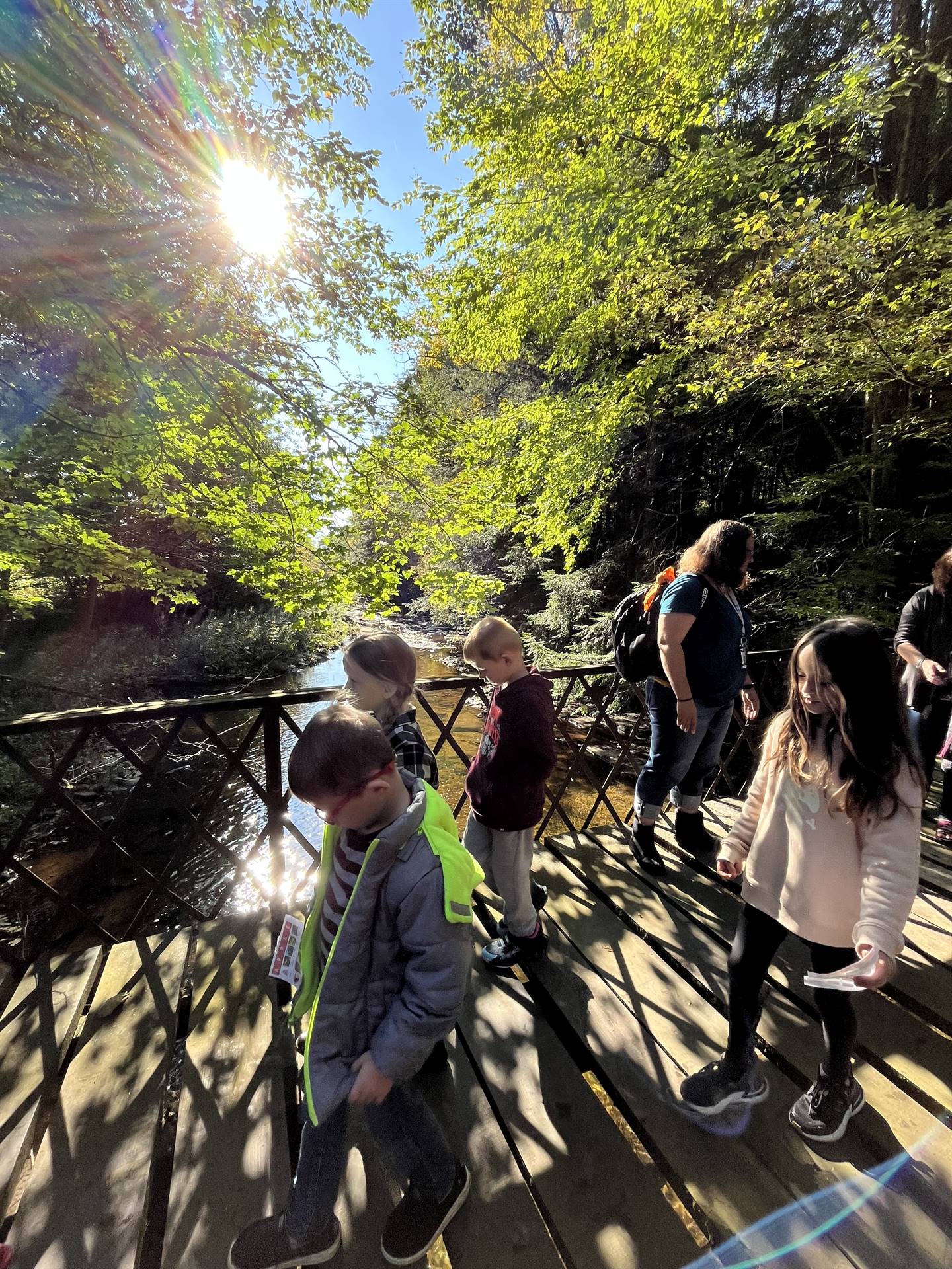 a group of students walking across a bridge