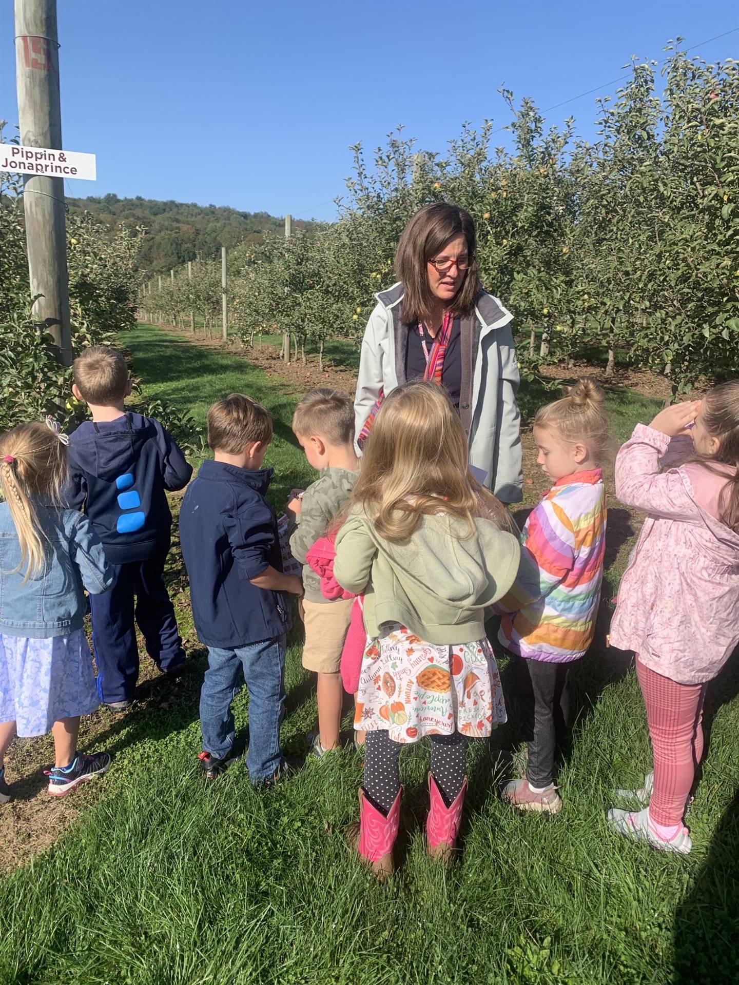 a group of kids outdoors with teacher