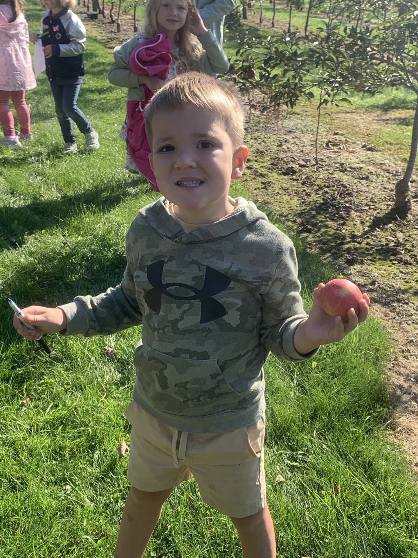 a student holds an apple.