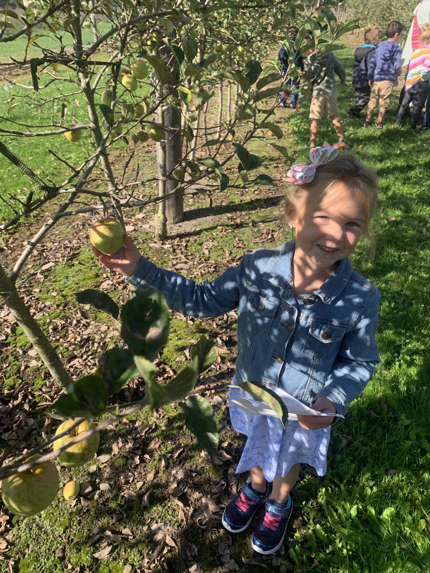 a student holds an apple.