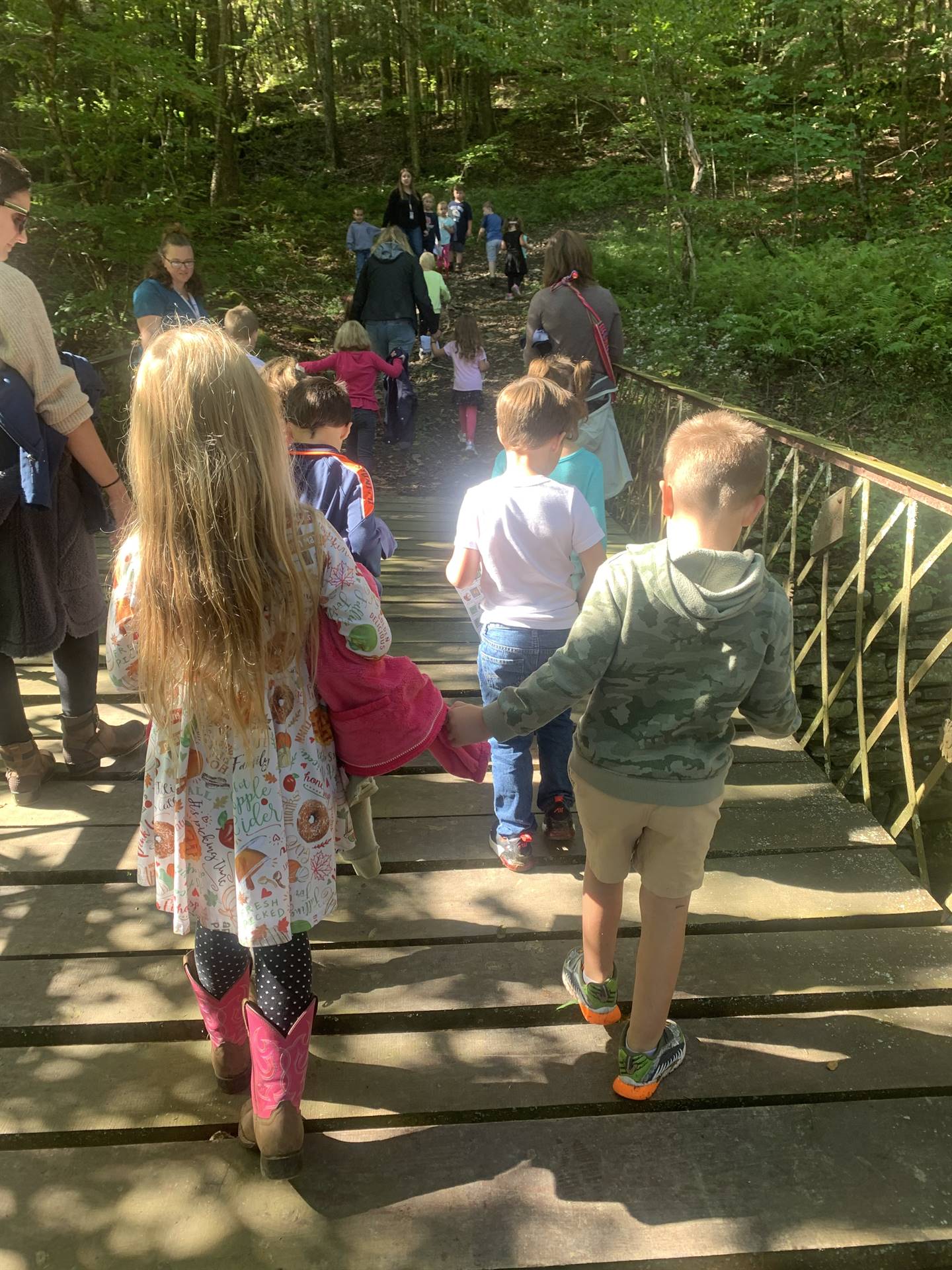 a group of students walking across a bridge