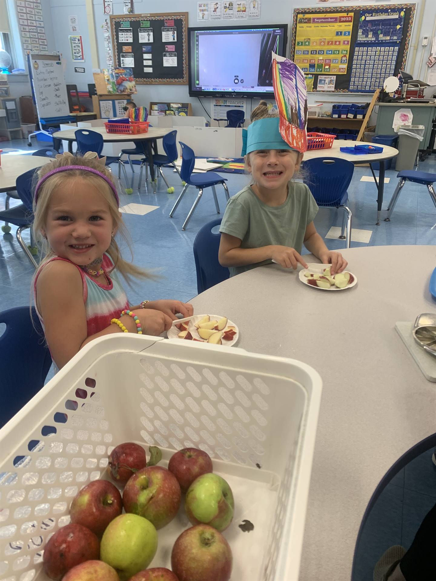 2 students with apples they picked and sliced