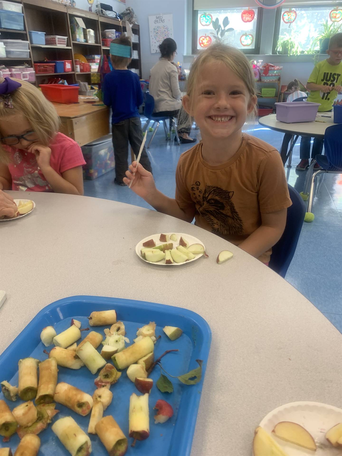 2 students with apples they picked and sliced