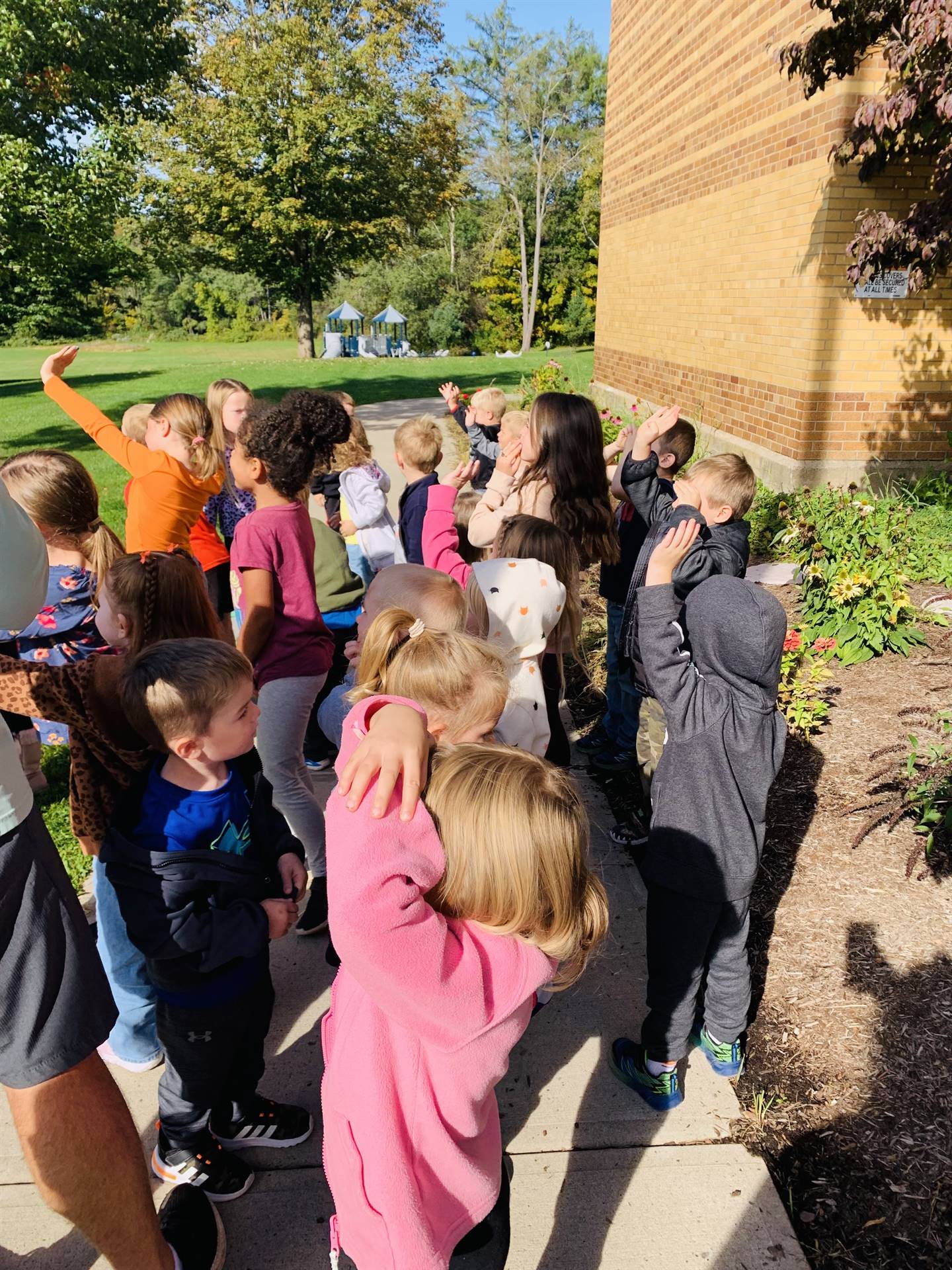 students waving goodbye to released butterflies.