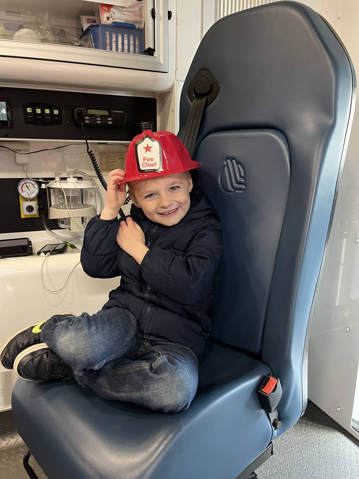 student sitting inside ambulance