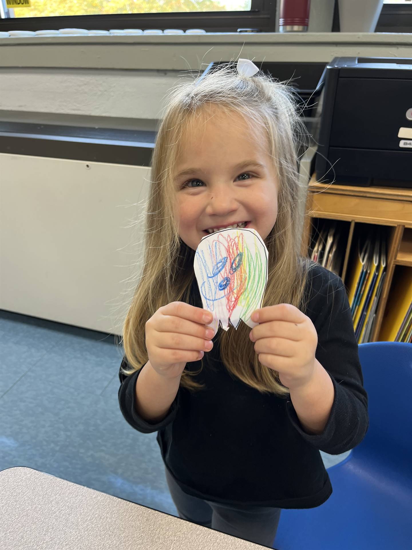 student with a paper ghost with happy emotion