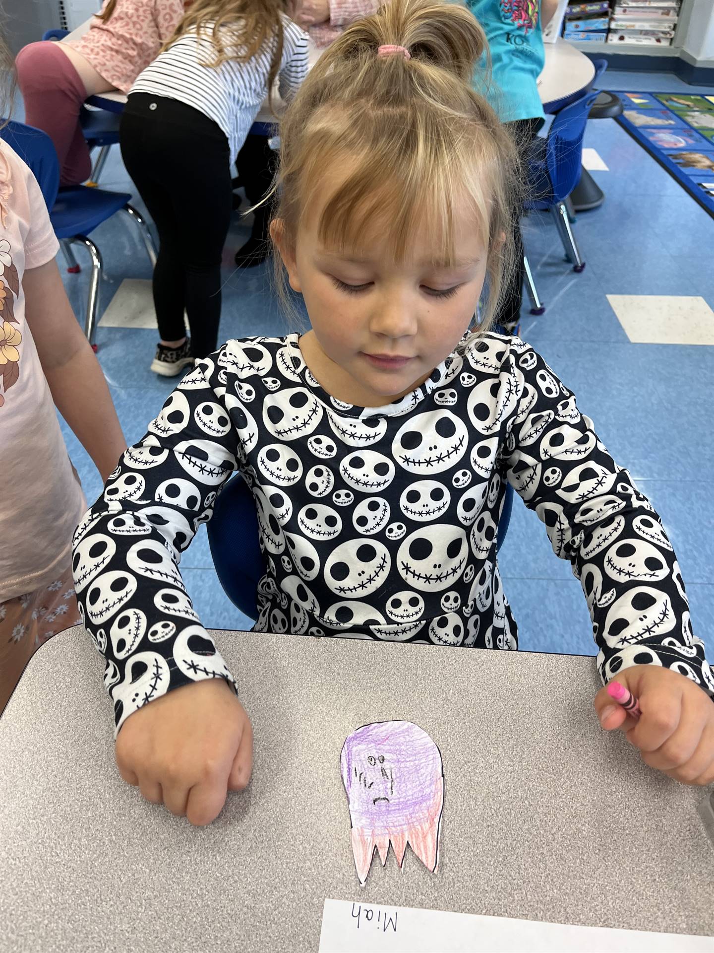 student with a paper ghost with a serious emotion