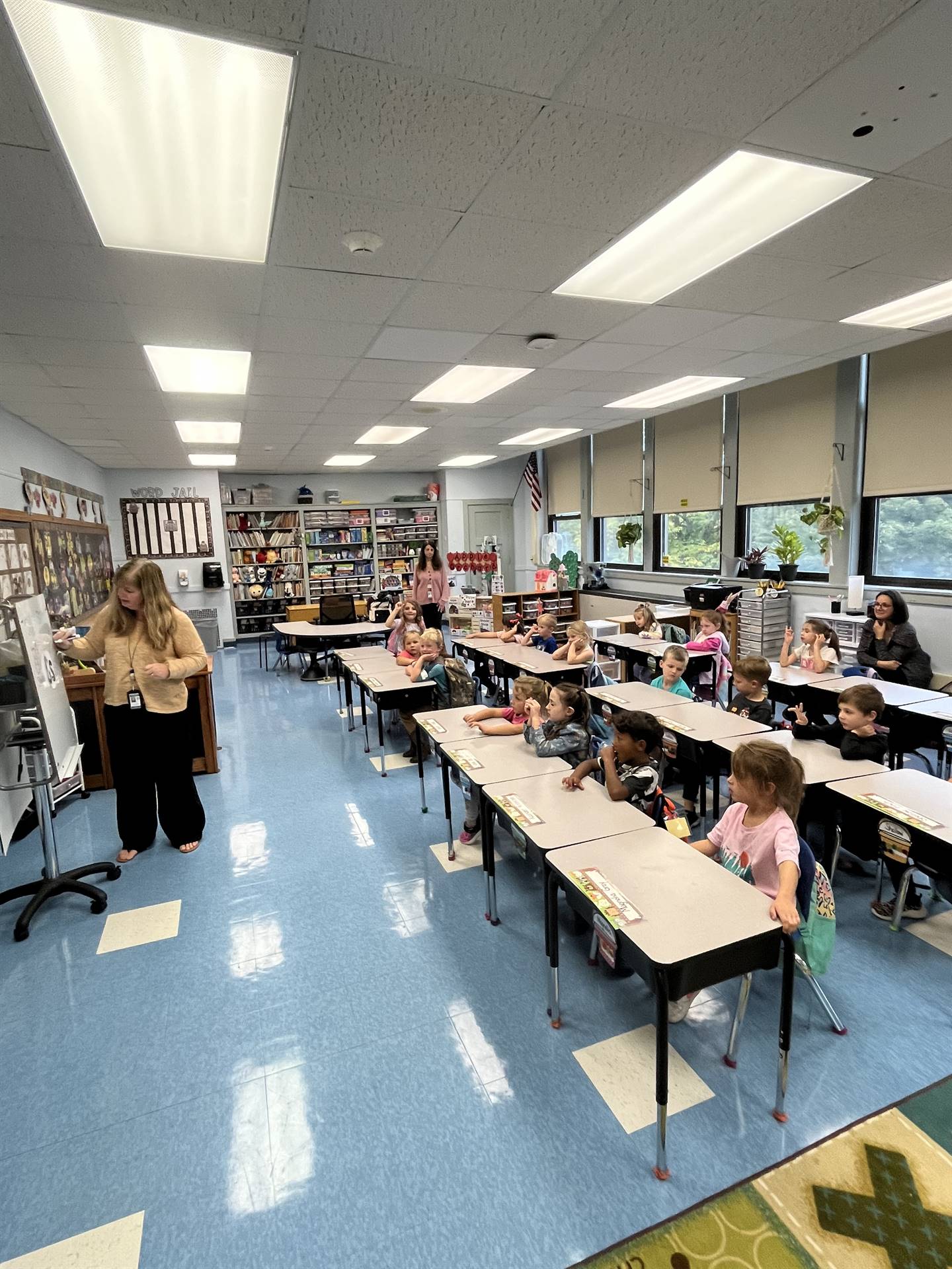 students listening to teacher in classroom